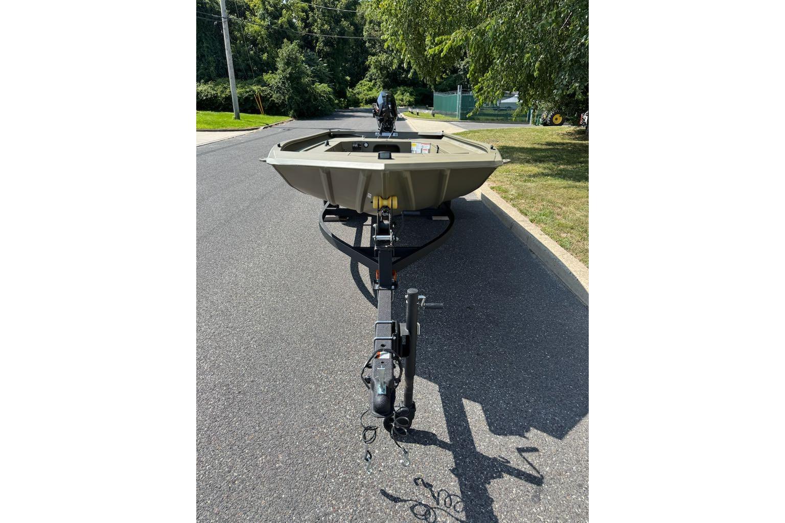 2026 Tracker Grizzly 1654 T Sportsman boat on trailer, parked on a suburban street.