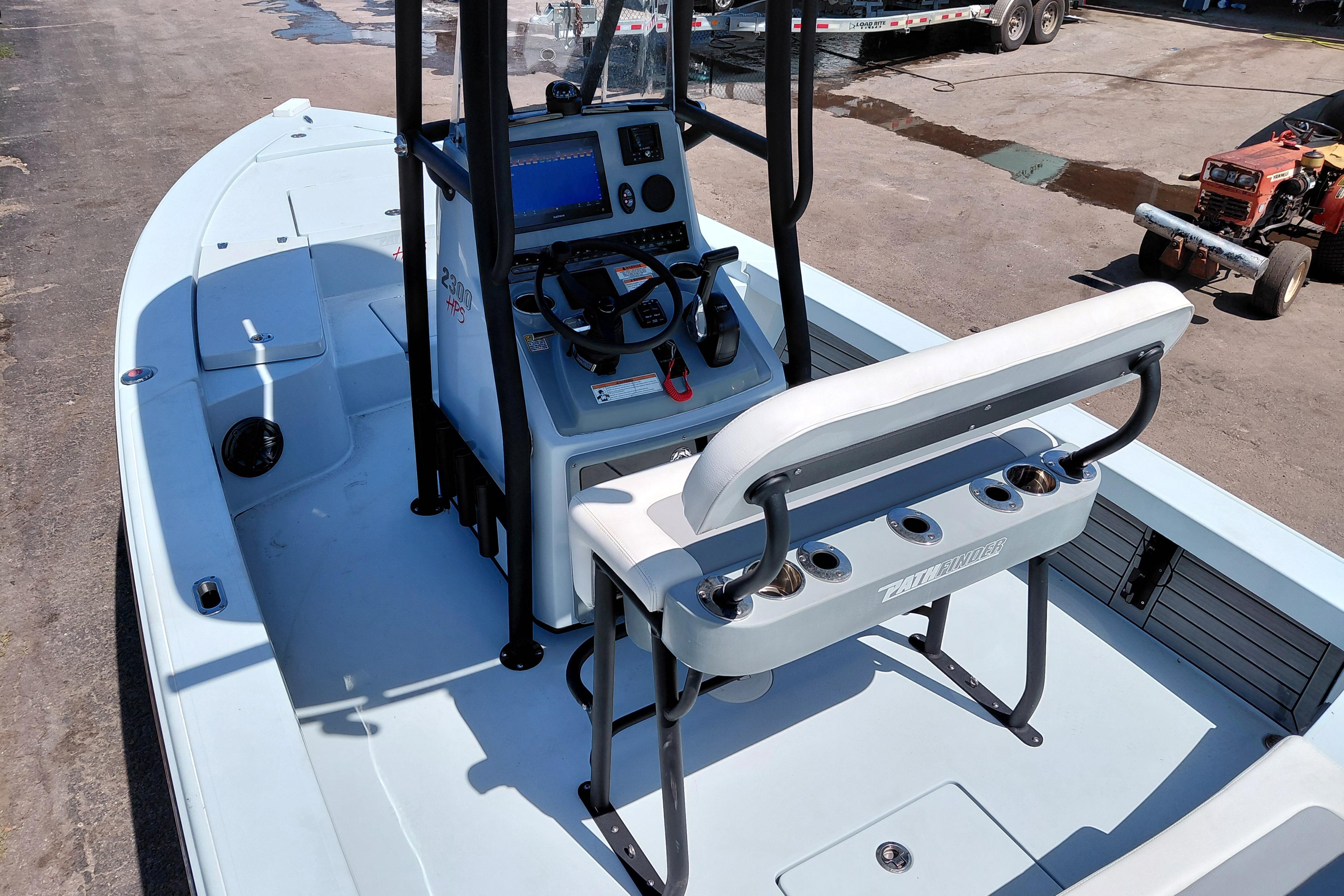 2022 Pathfinder 2300 HPS boat interior with console and seating, docked outdoors.