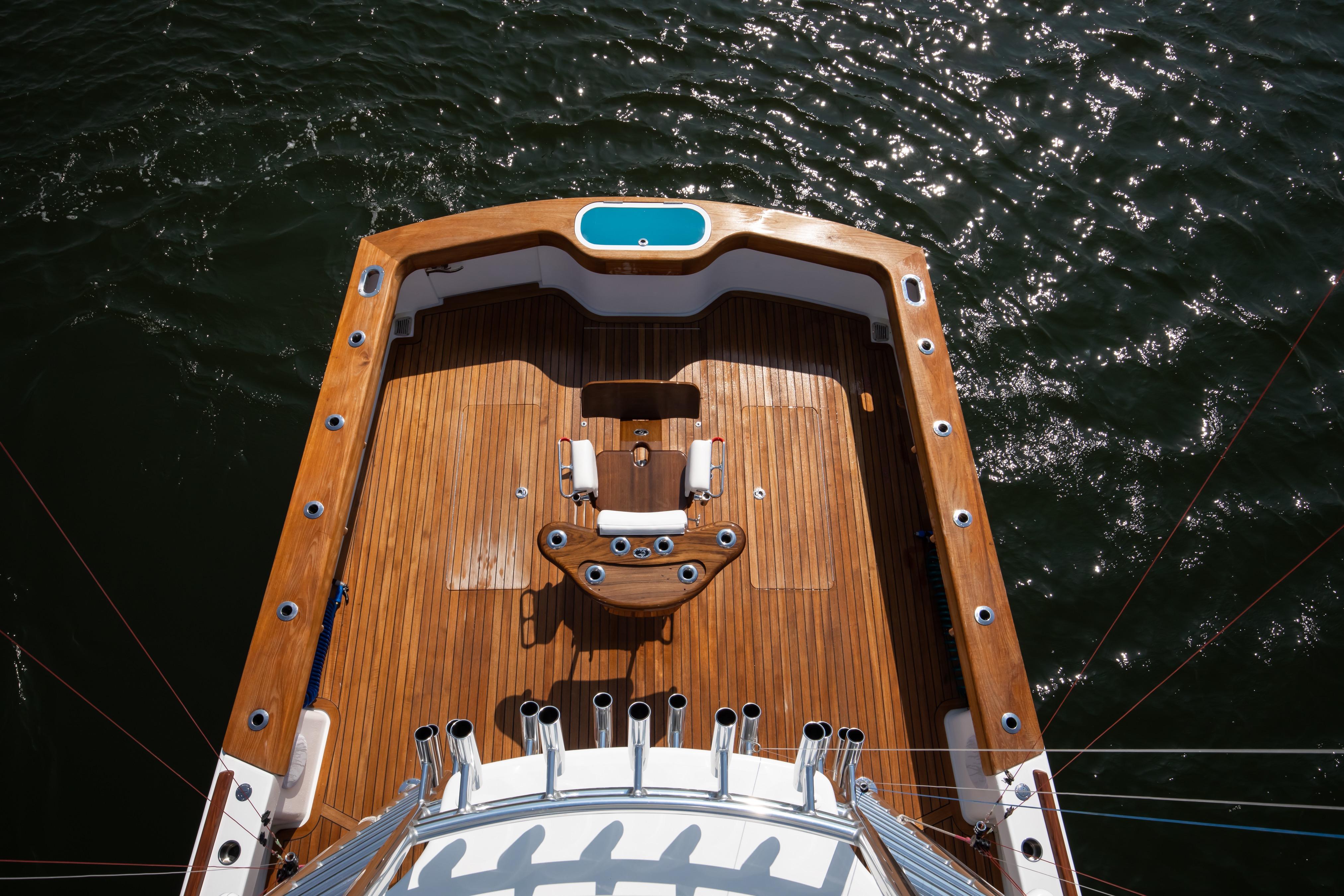 Aerial view of 2026 Release Boatworks 46 Walkaround's teak deck on water.