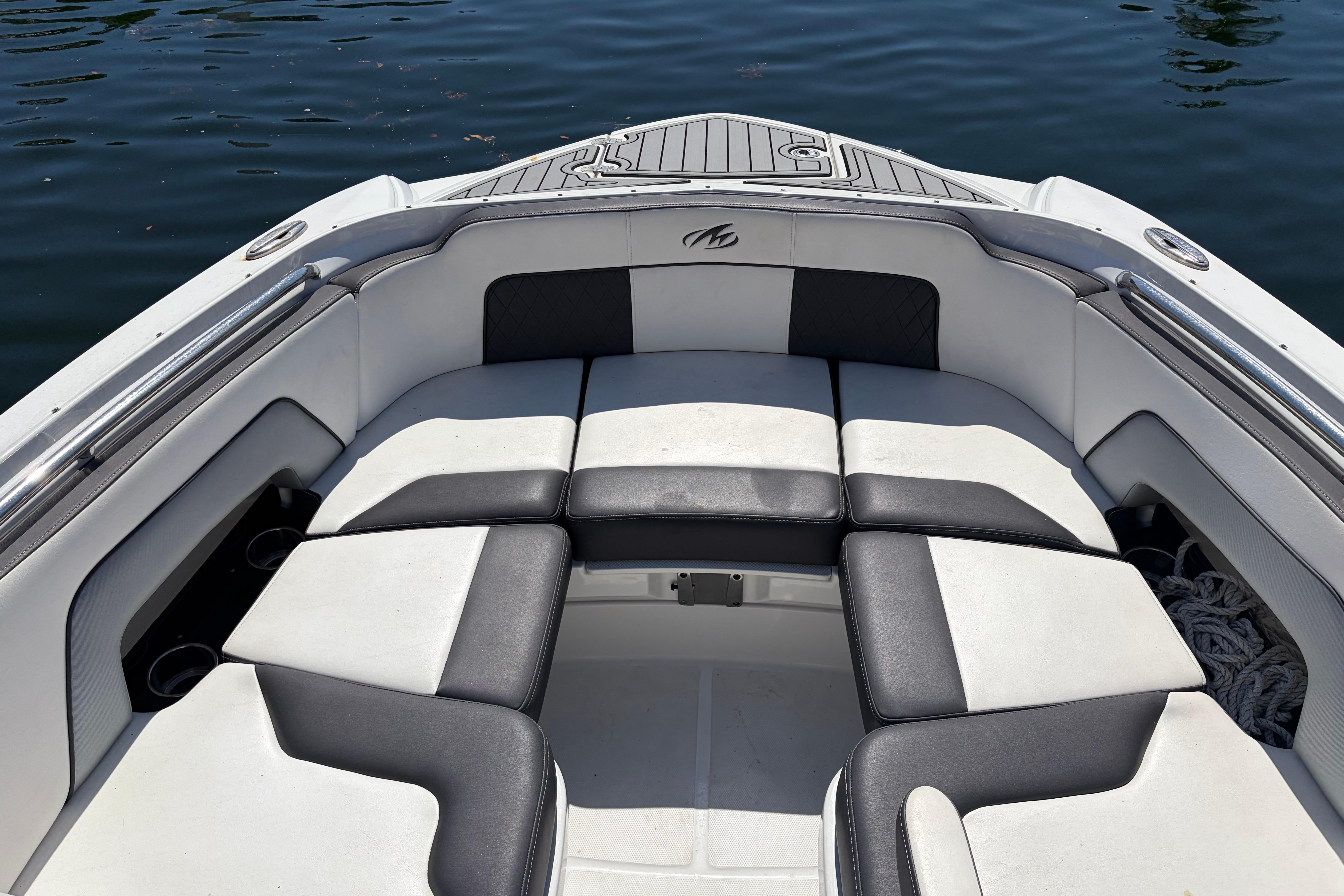 Bow seating area of a 2022 Monterey M-65 boat on water.