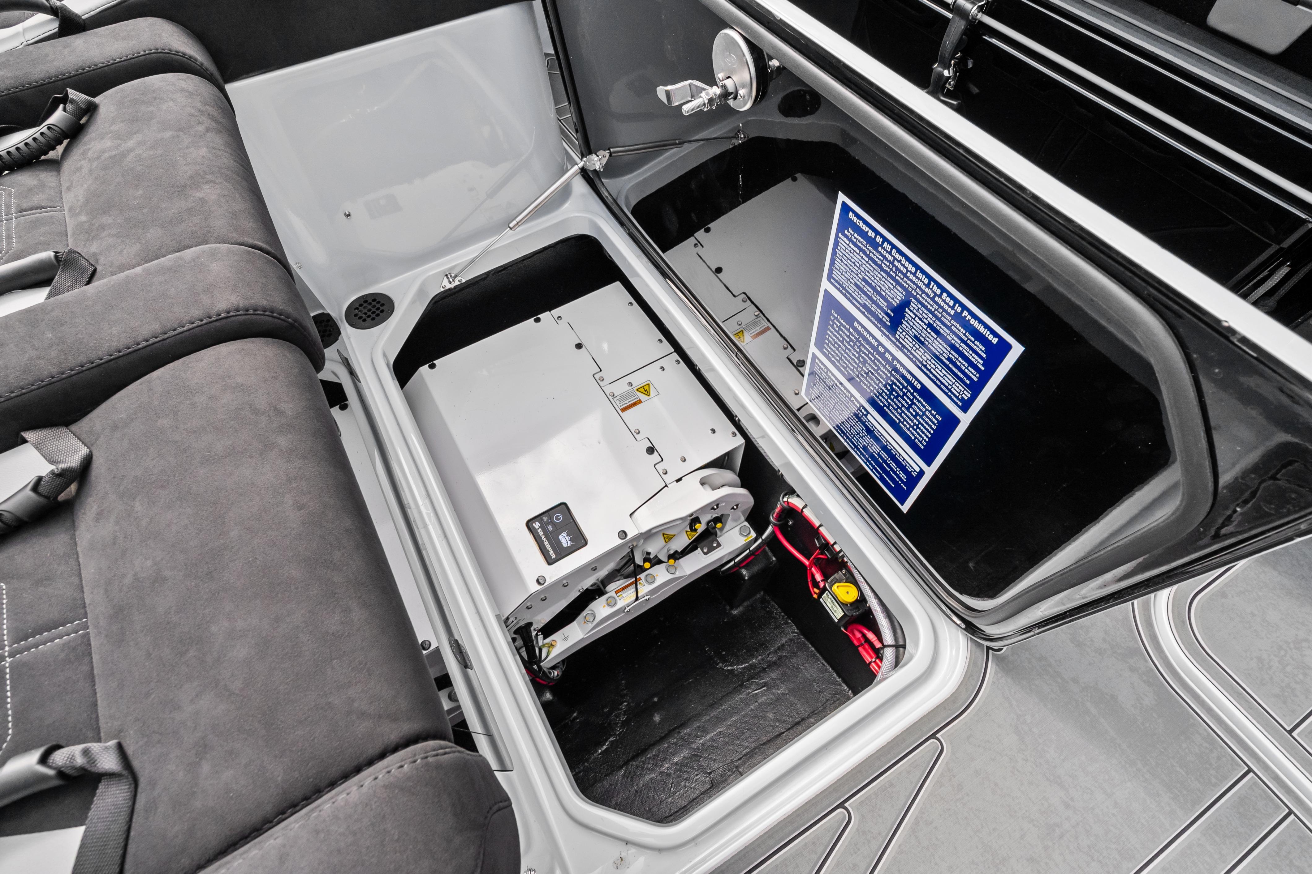 Interior view of 2027 Mystic Powerboats M4200, showcasing storage compartment and seating.