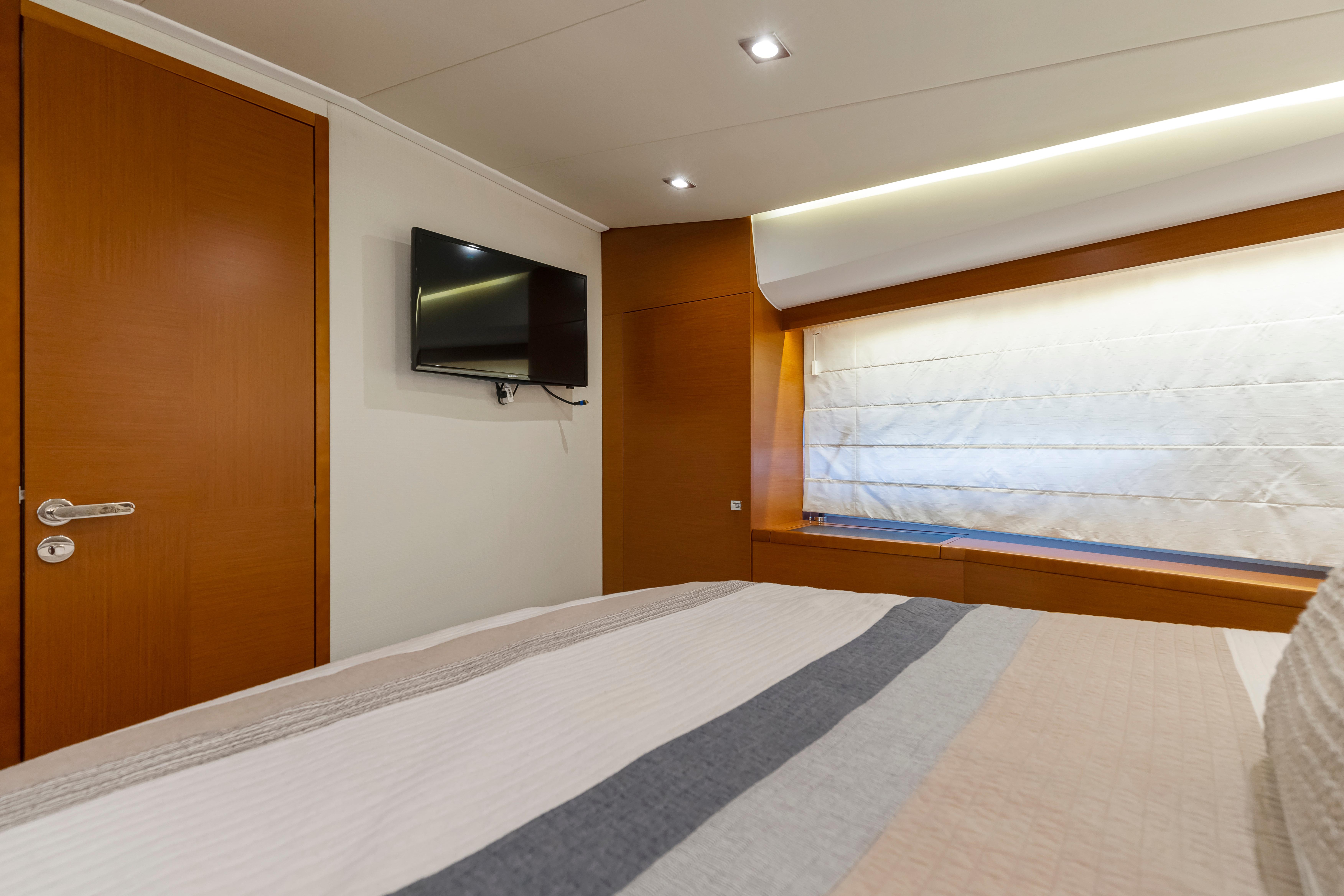 Luxurious interior of 2017 Prestige 500 yacht with modern decor and wall-mounted TV.