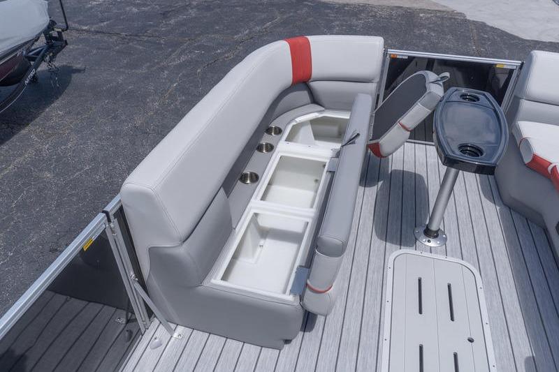 2026 SunCatcher Select 322SL boat interior with gray seating, storage compartments, and a table.