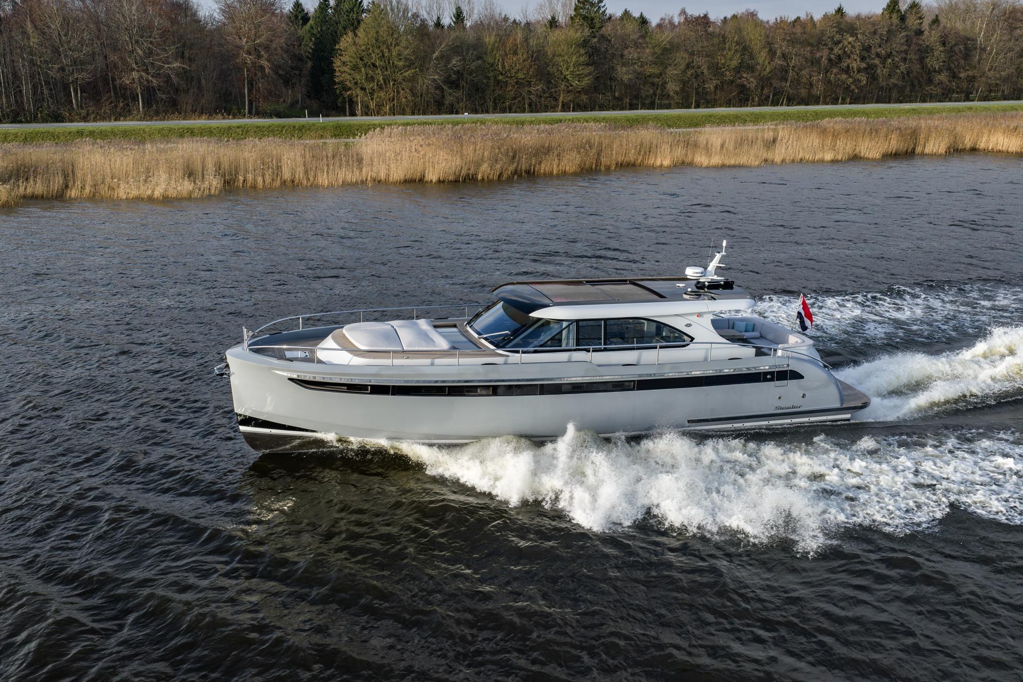 Luxury 2022 Steeler 56S Aluminium yacht cruising on a scenic waterway.