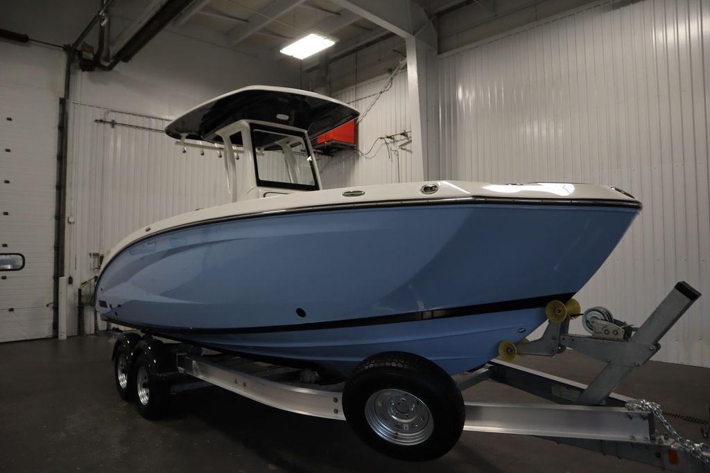 2026 Yamaha Boats 255 FSH Sport E in a showroom, on a trailer.
