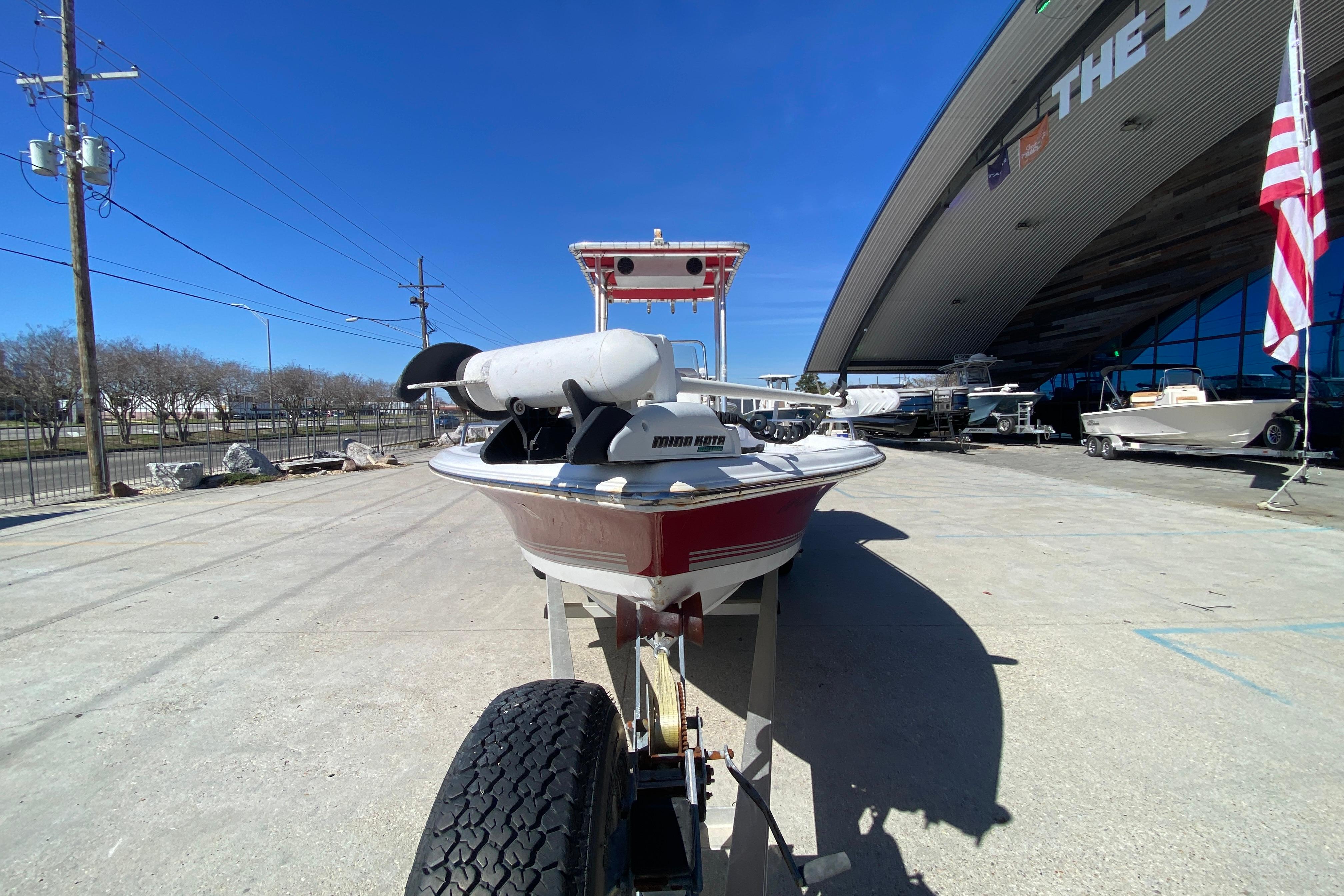 2005 Sea Pro SV2400CC Bay Boat on trailer outside a showroom.