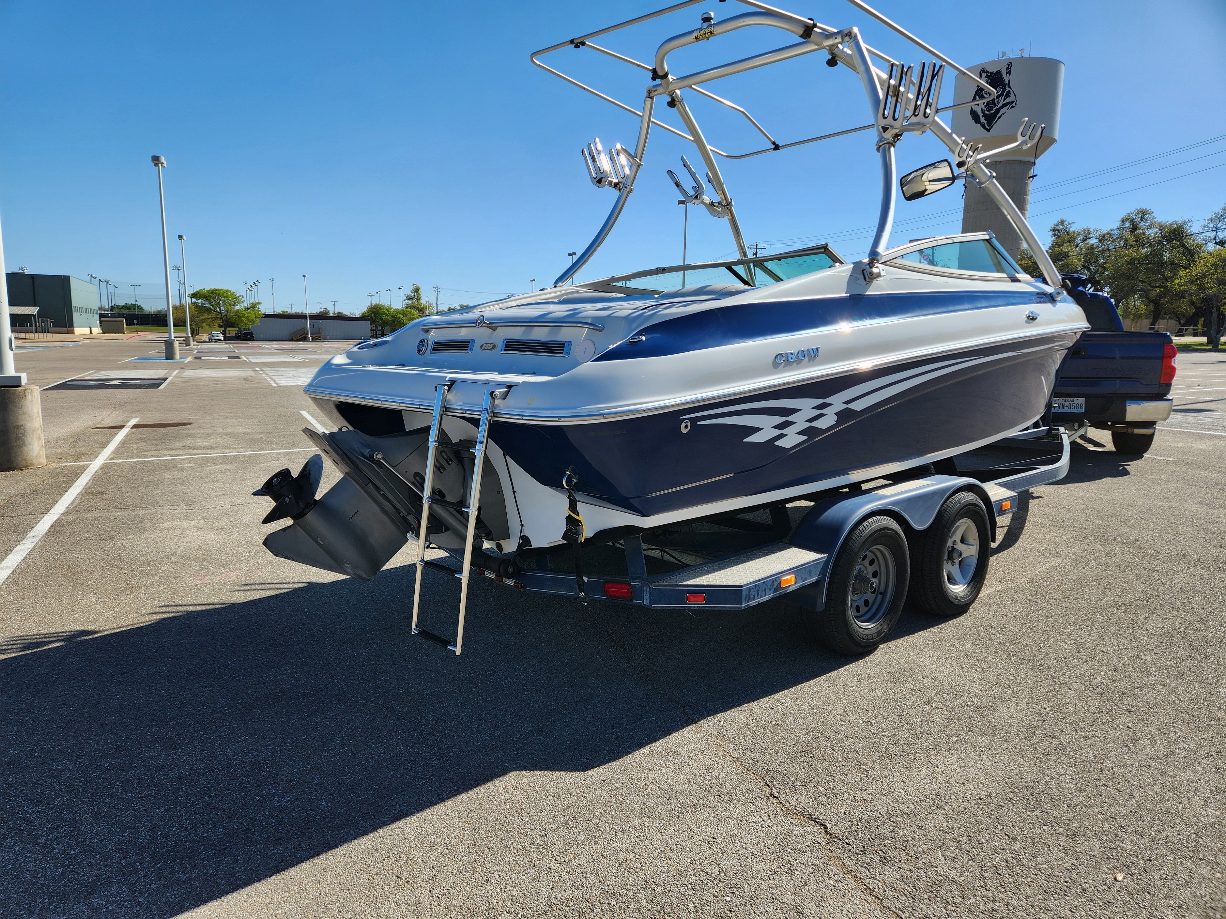 2003 Crownline 225 BR boat parked on trailer outdoors.
