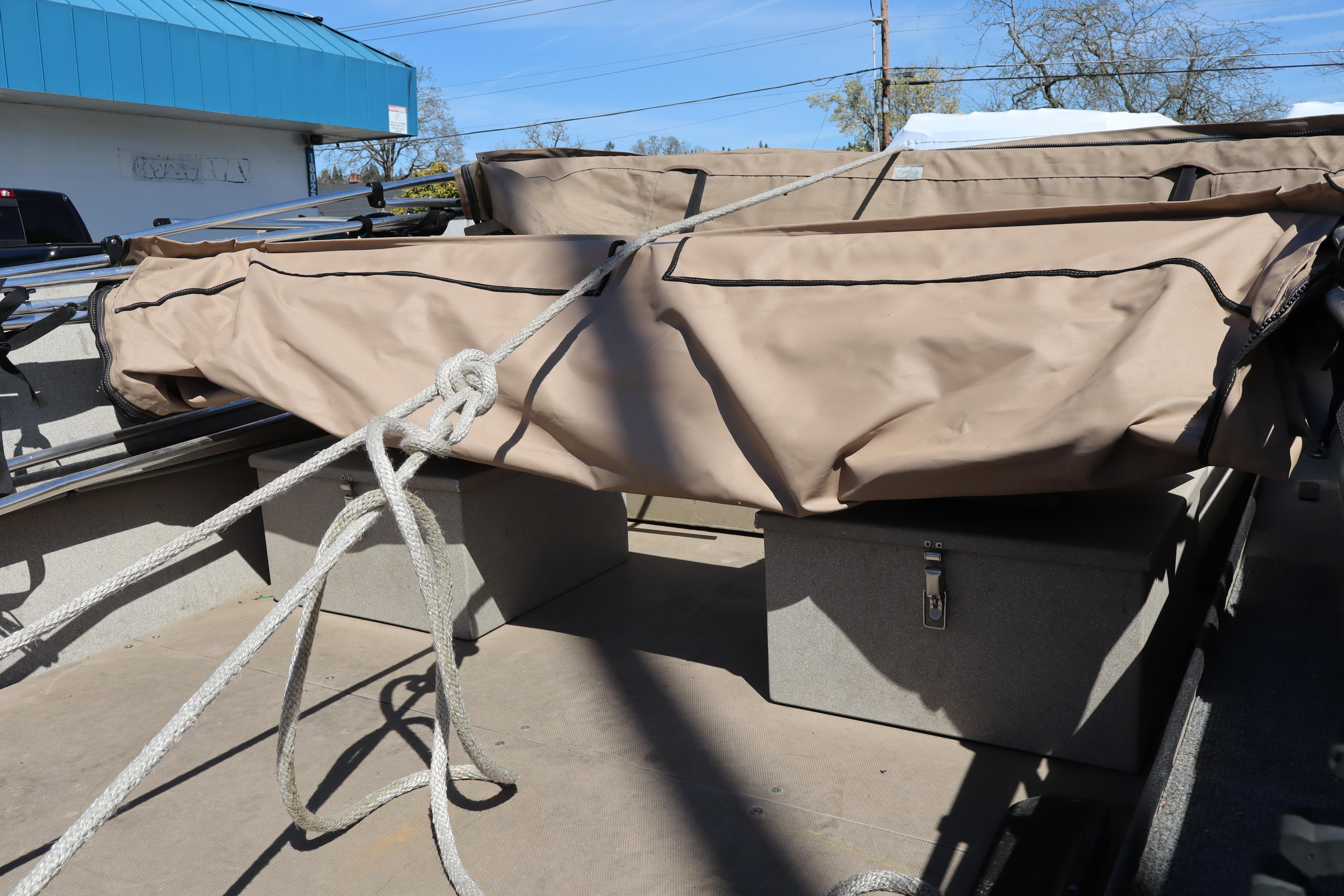 2002 Alumaweld SUPER VEE LS boat interior with covered equipment and storage compartments.
