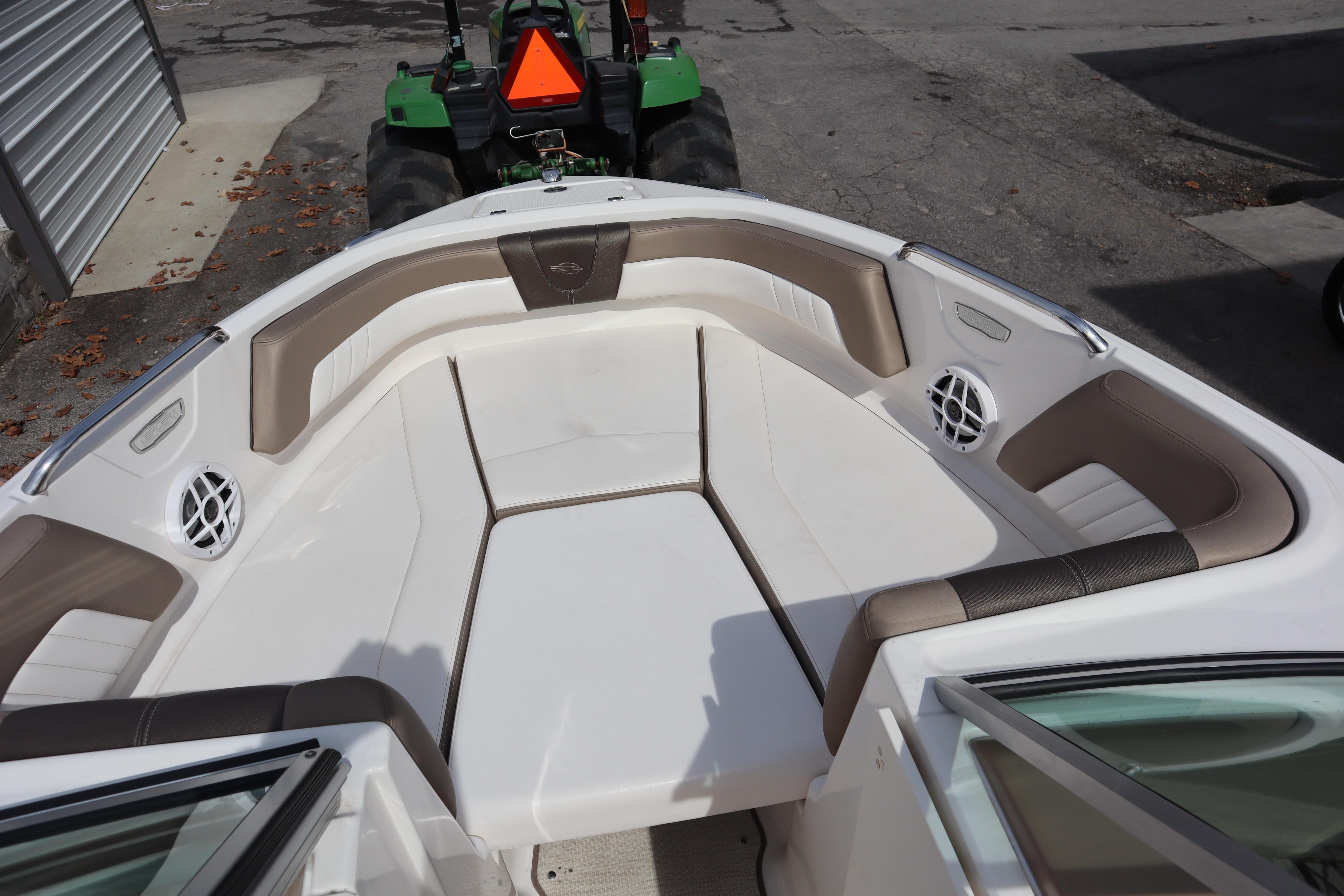 2021 Chaparral 21 SSi boat interior with cushioned seating and speakers.