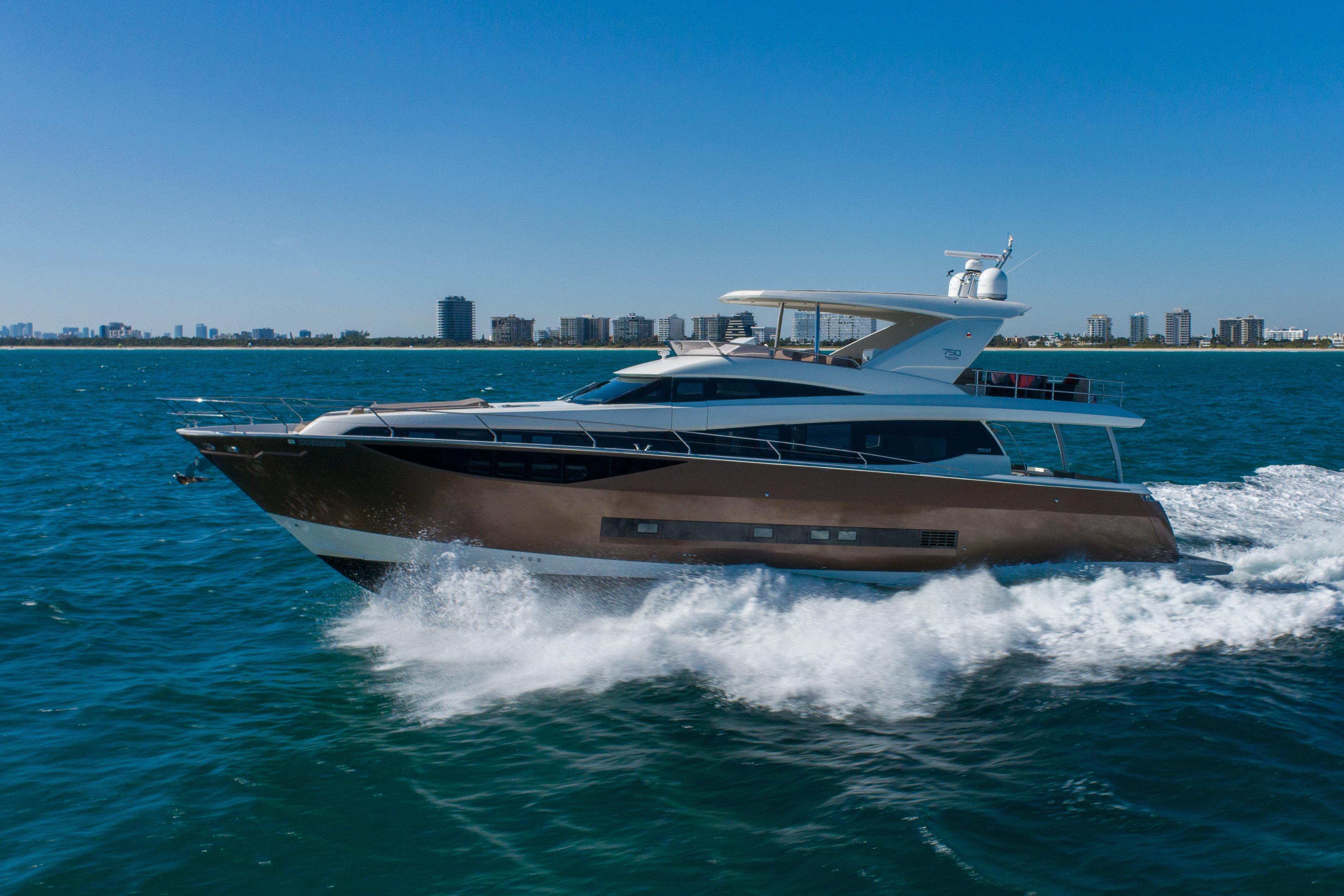 Luxury 2015 Prestige 750 yacht cruising on blue ocean near city skyline.