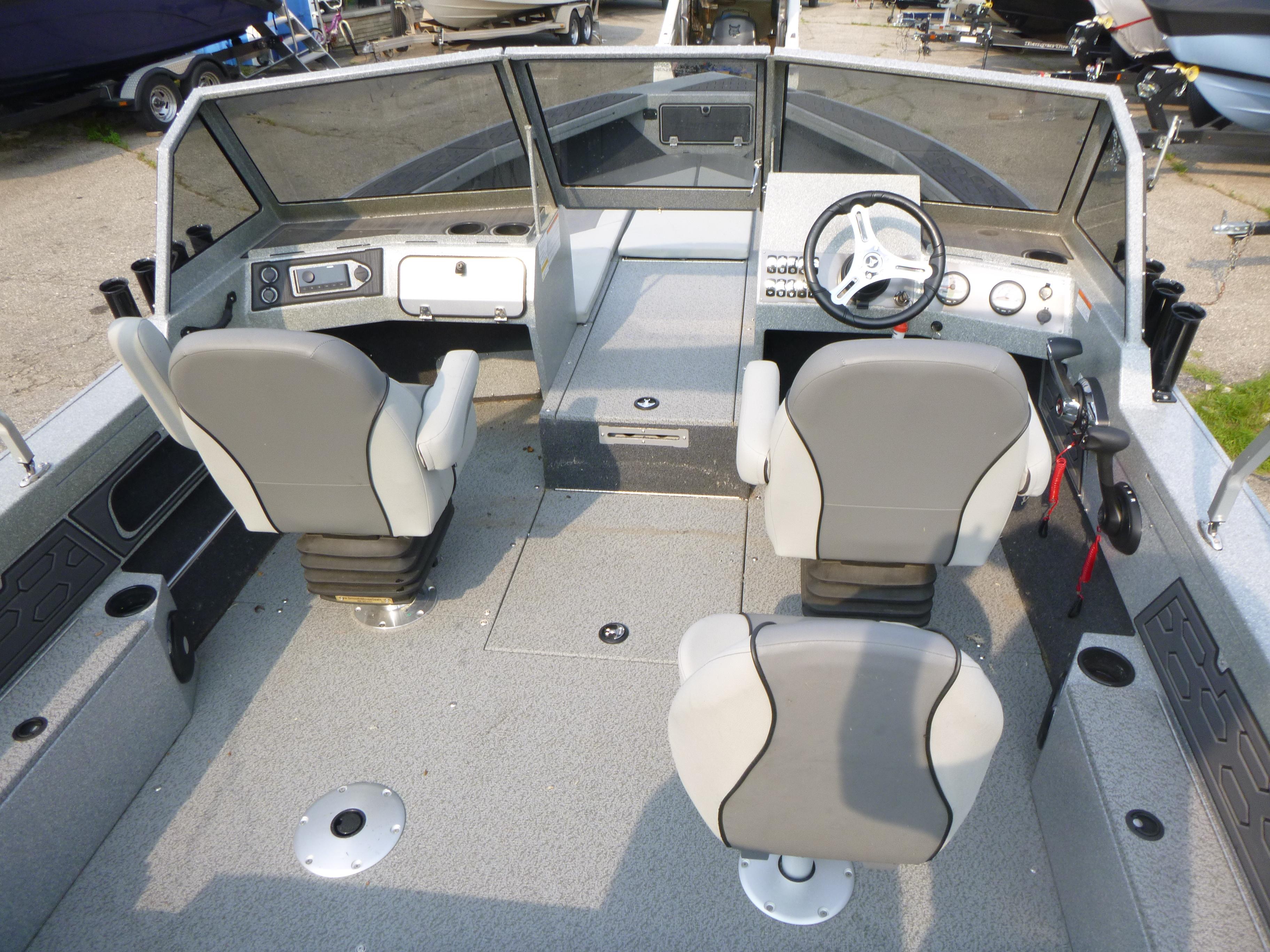 Interior of 2025 KingFisher 2125 Arrow Sport boat with dual seats and steering console.