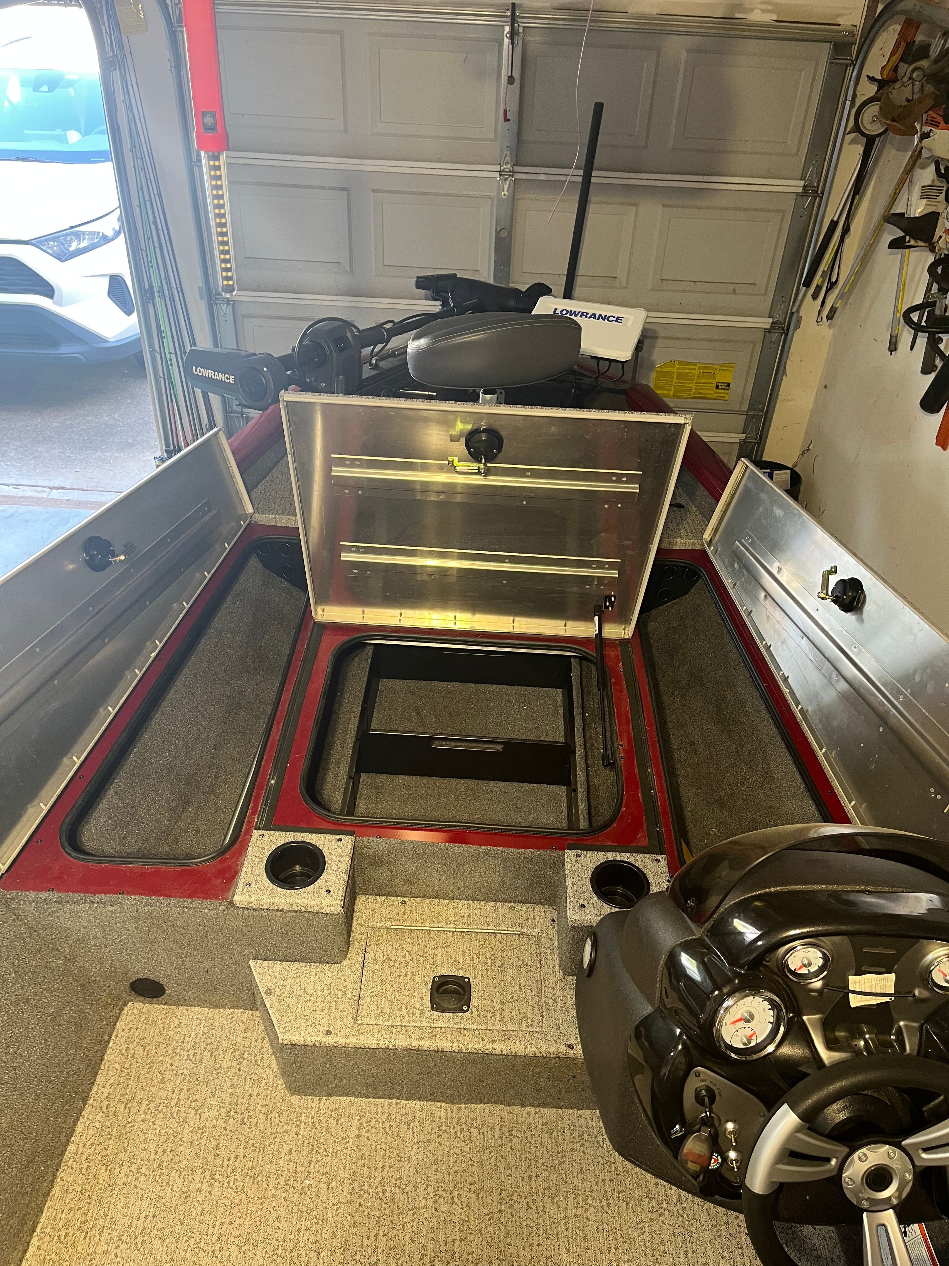 Interior view of a Bass Tracker PRO 175 TEAM TXW Tournament Edition boat with storage and helm.