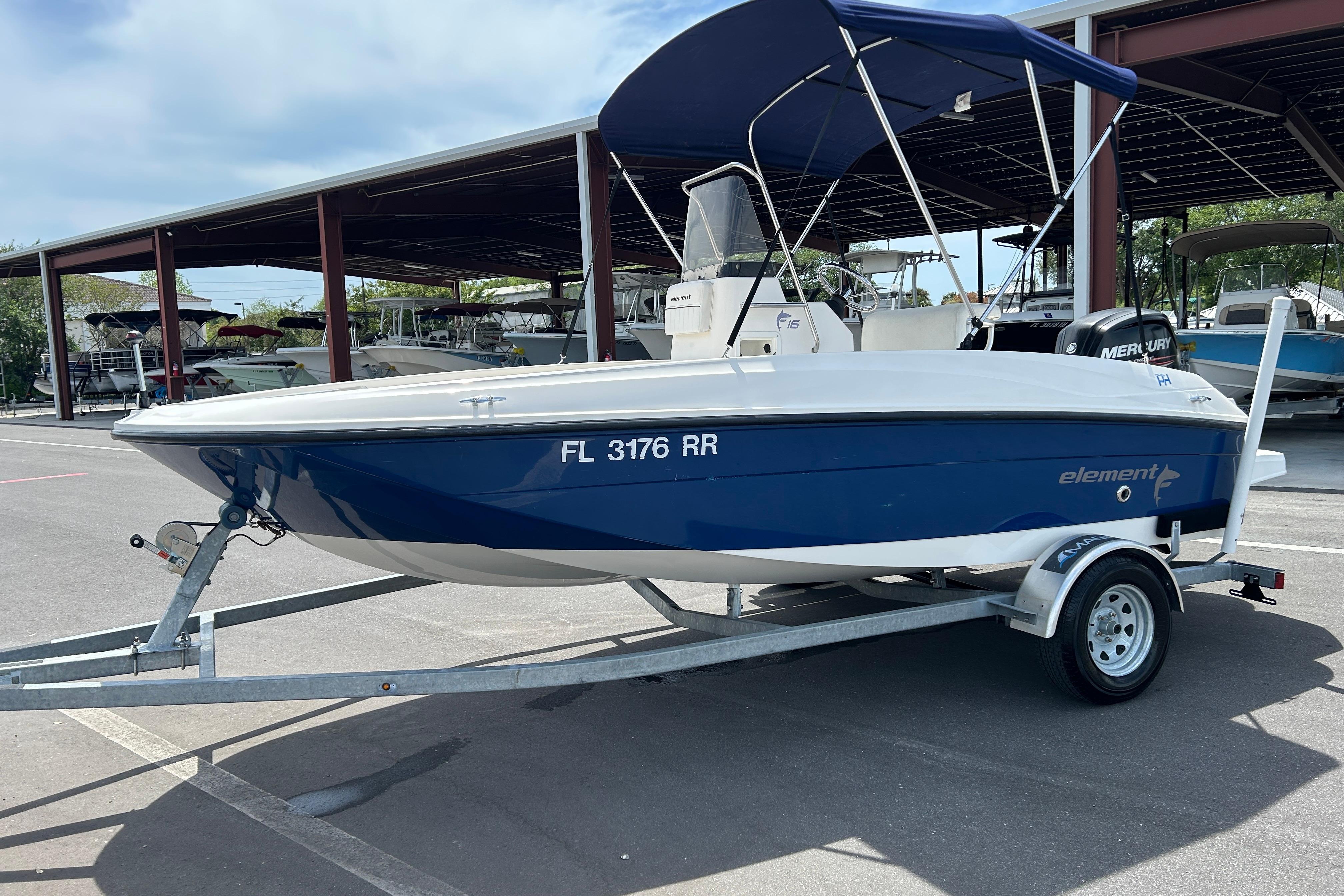 2018 Bayliner Element F16 boat on trailer with blue hull and canopy.