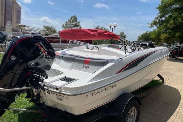 2024 Tahoe T18 boat with red canopy and powerful outboard motor on trailer.