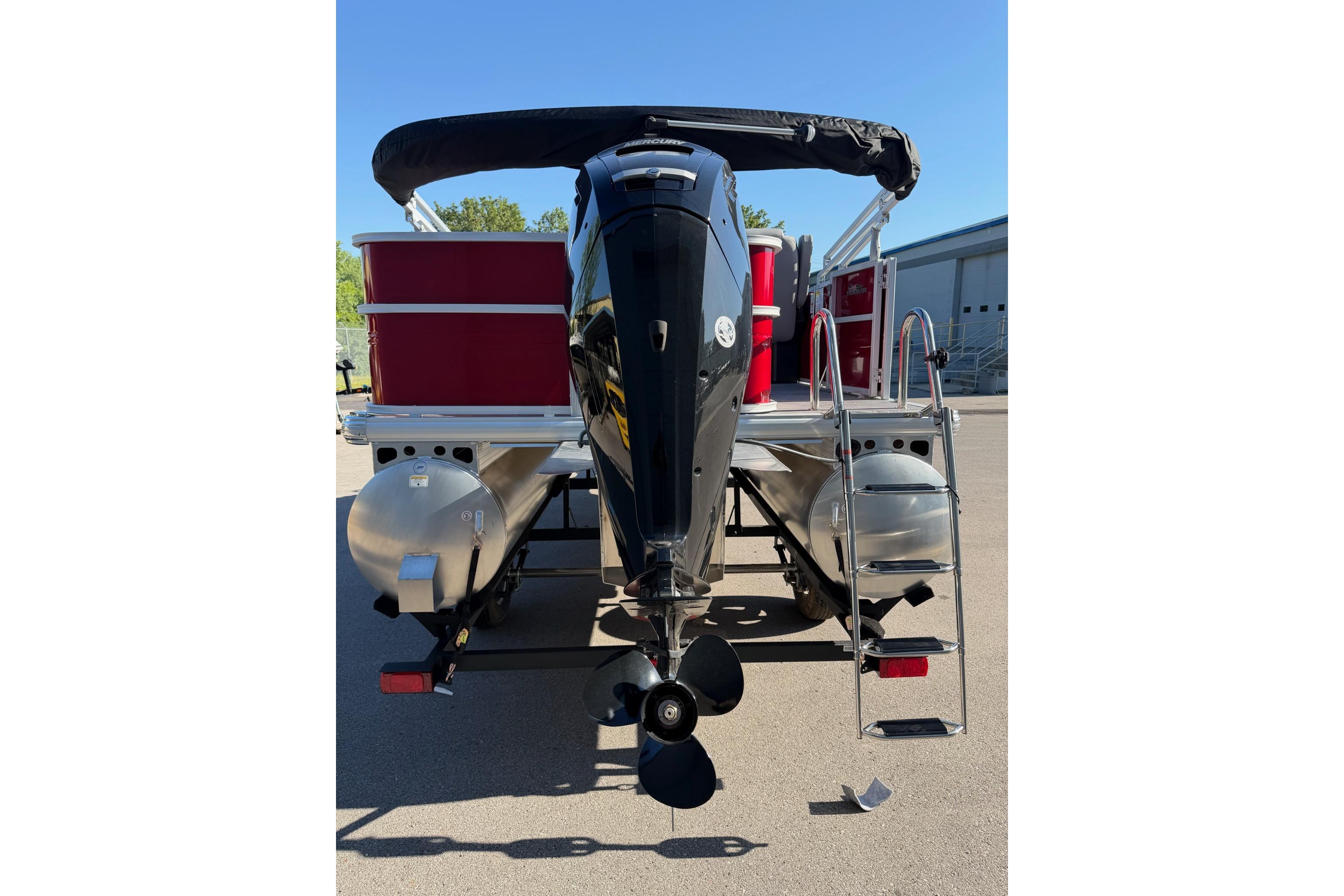 2026 Sun Tracker Party Barge 18 DLX pontoon boat, rear view with motor and ladder.