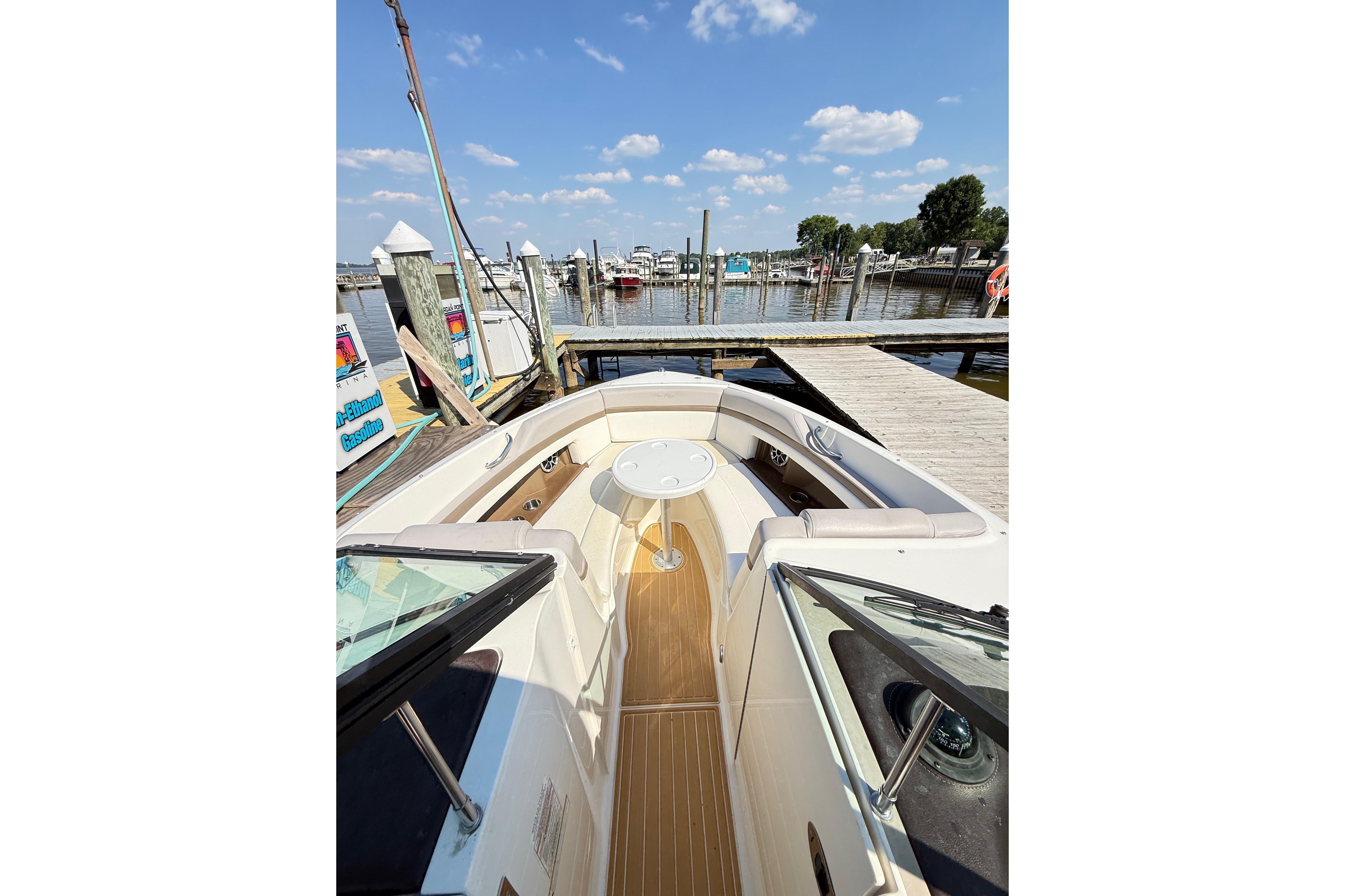 2011 Sea Ray 270 SLX boat docked at marina under blue sky.