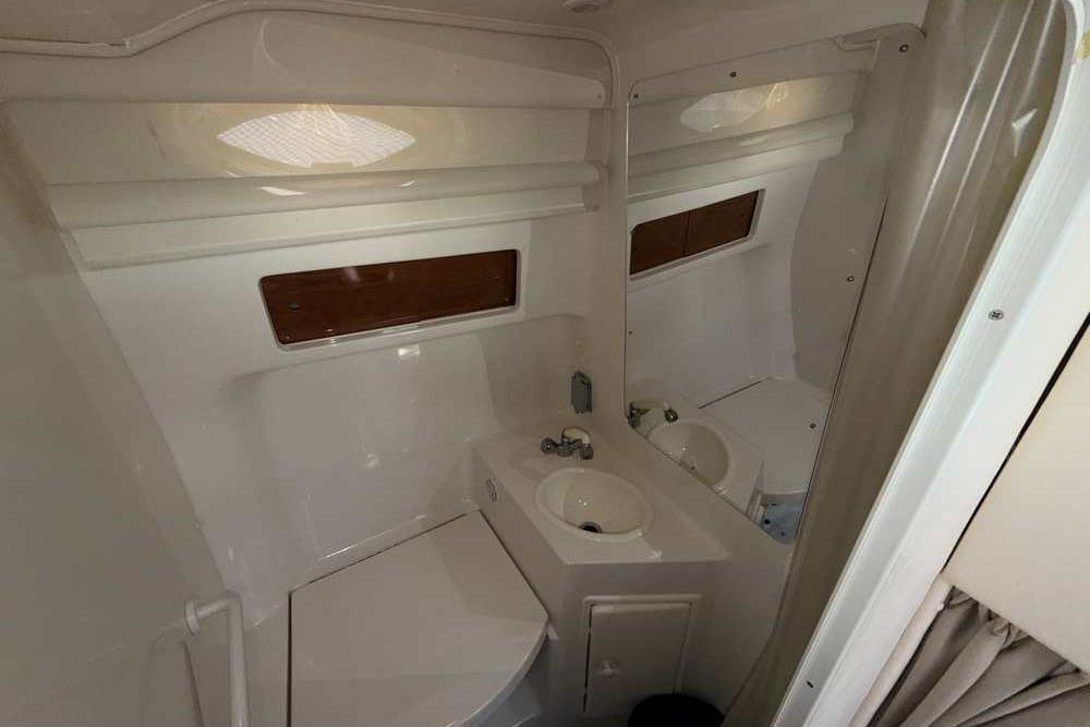 Bathroom interior of a 2001 Monterey 282 Cruiser boat, featuring sink and mirror.