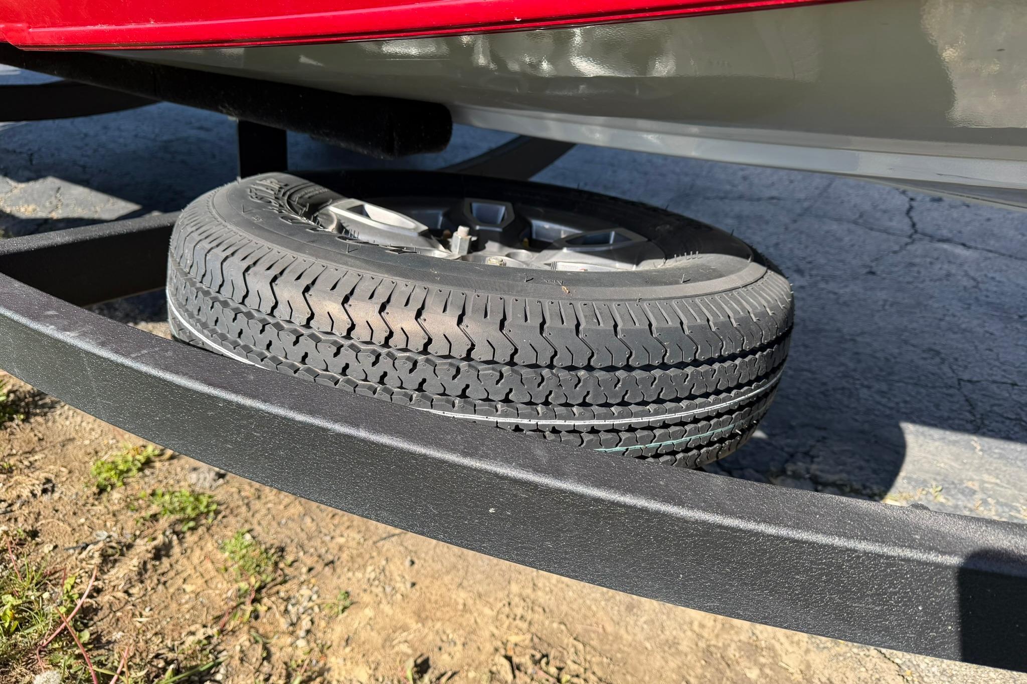 2024 Tracker Pro Team 175 TXW trailer with spare tire mounted underneath.
