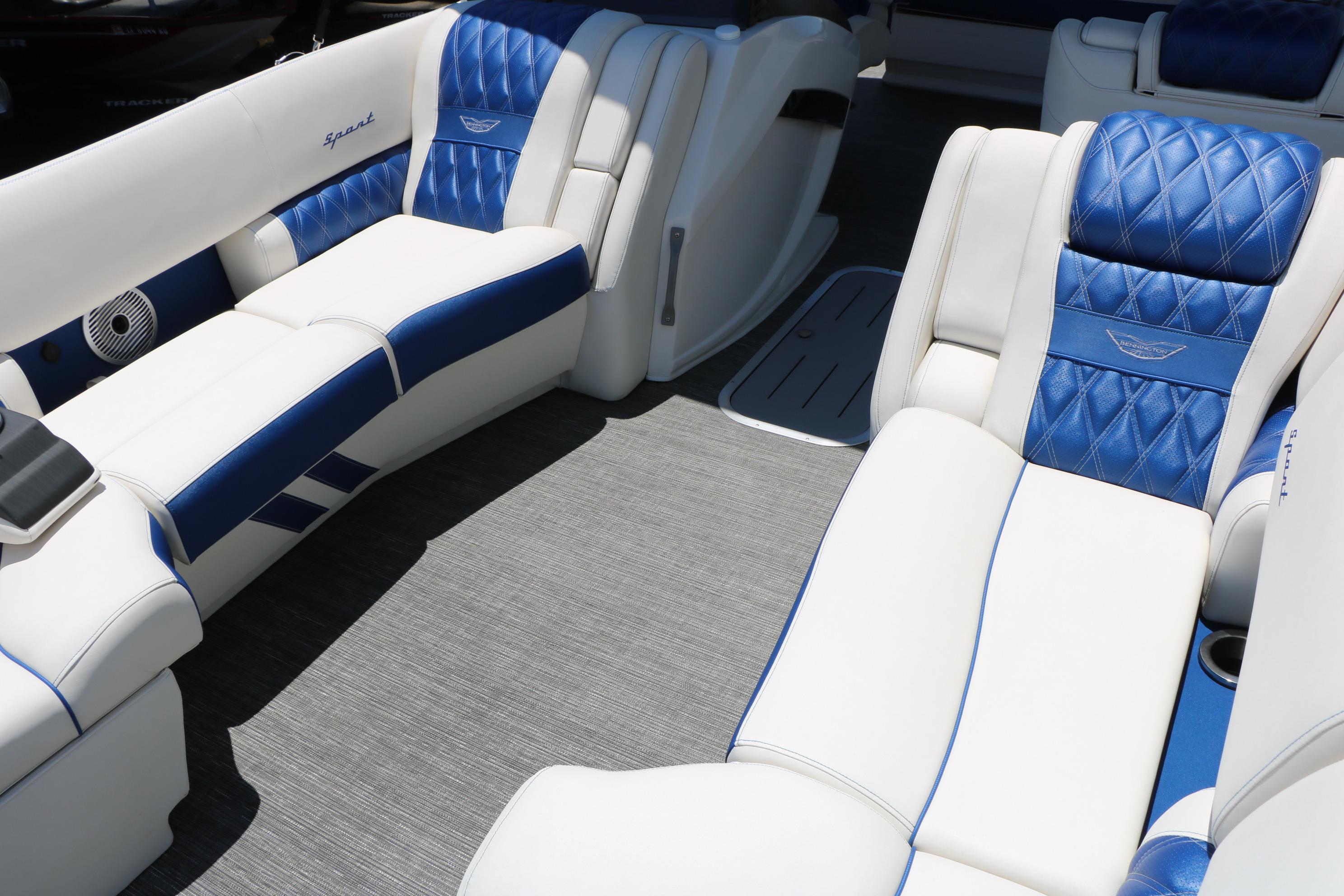 2024 Bennington 23 RX Swingback boat interior with blue and white luxury seating.