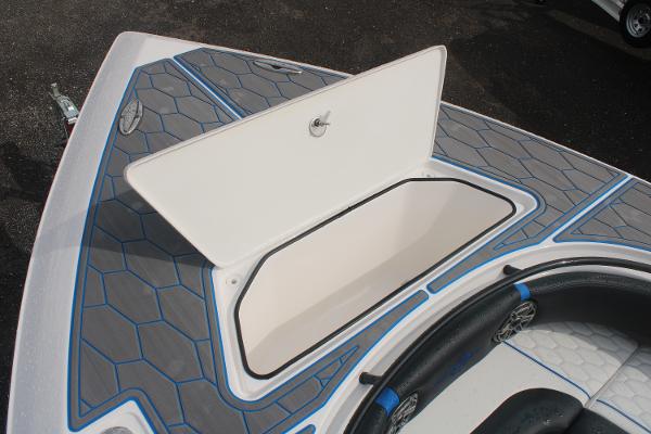 2024 Fountain 34 SC boat with open storage compartment, featuring blue and gray deck design.
