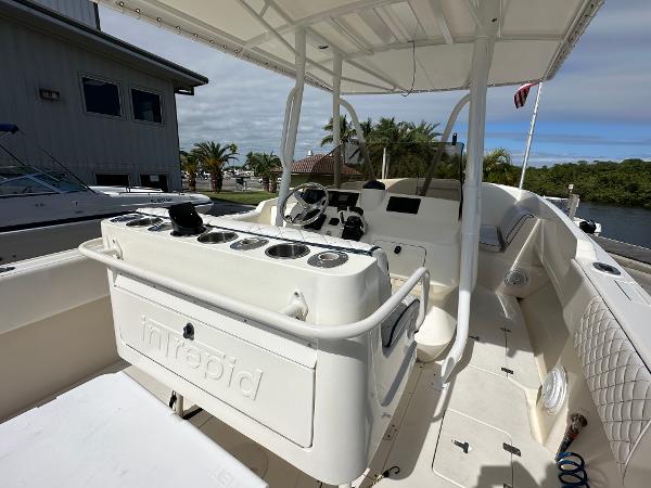 2005 Intrepid 323 boat interior with helm, seating, and rod holders.