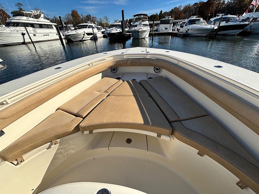 2016 Scout 350 LXF boat with cushioned seating, docked in a marina.