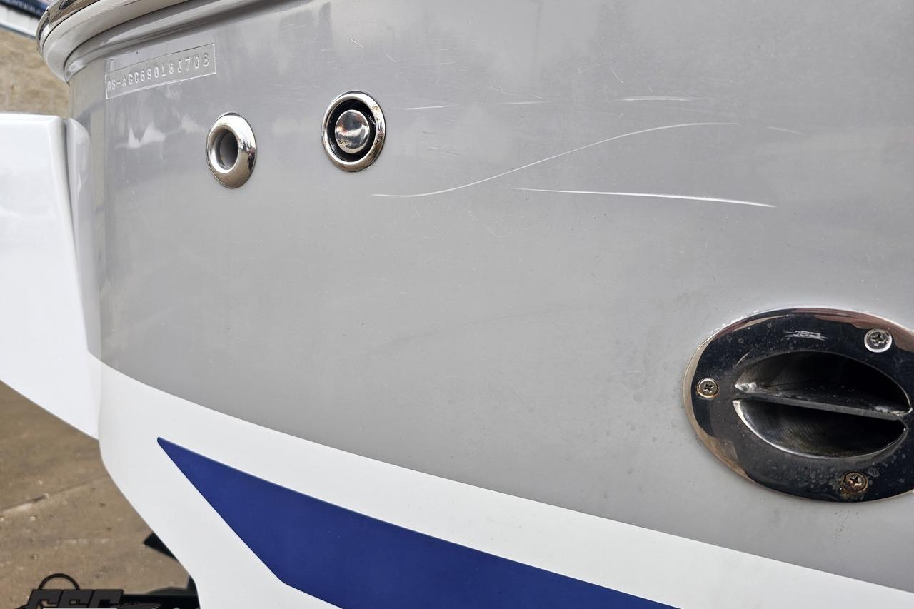 Close-up of 2008 Baja 335 Performance boat hull with visible scratches and fittings.