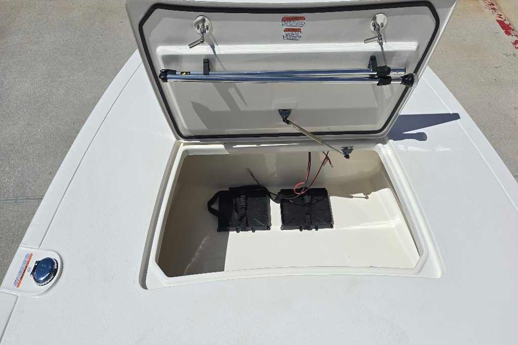 Open storage compartment of 2026 Mako 18 Pro Skiff boat, showing interior details.
