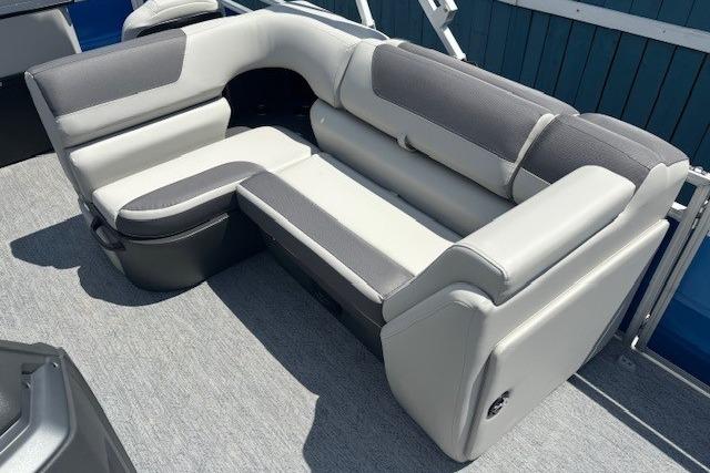2026 Sun Tracker Fishin' Barge 20 DLX, gray and white seating, outdoor boat interior.