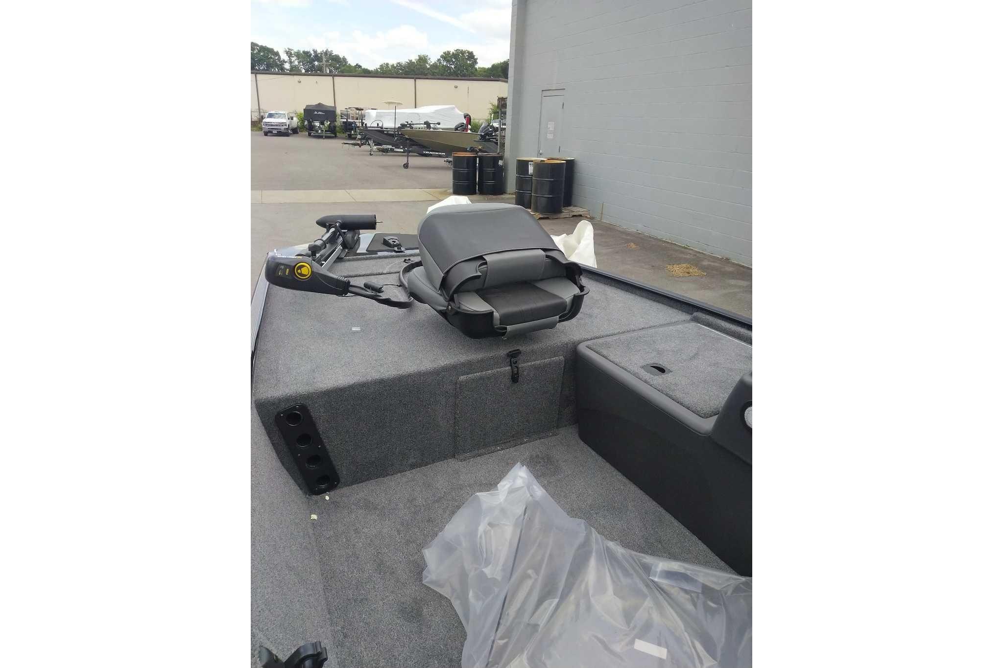 2026 Tracker Bass Tracker Classic XL boat interior with seating and equipment, parked outdoors.