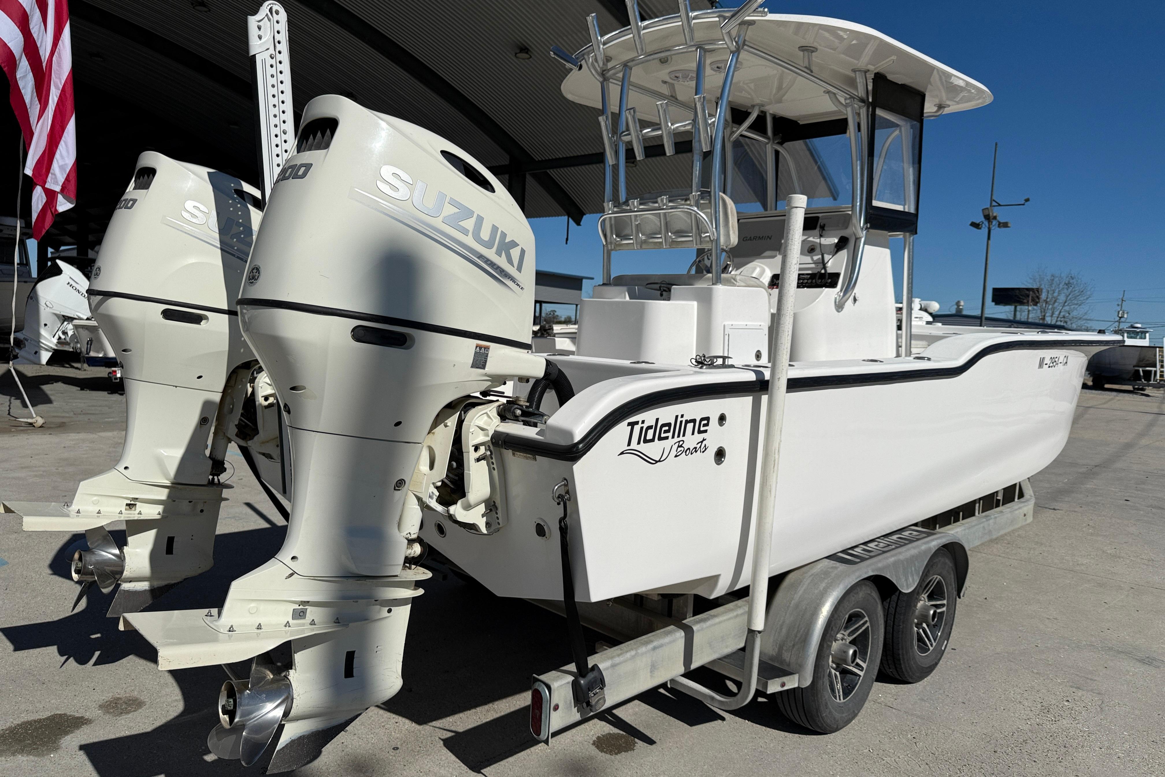 2020 Tideline 235 Hybrid boat with dual Suzuki outboard motors on a trailer.