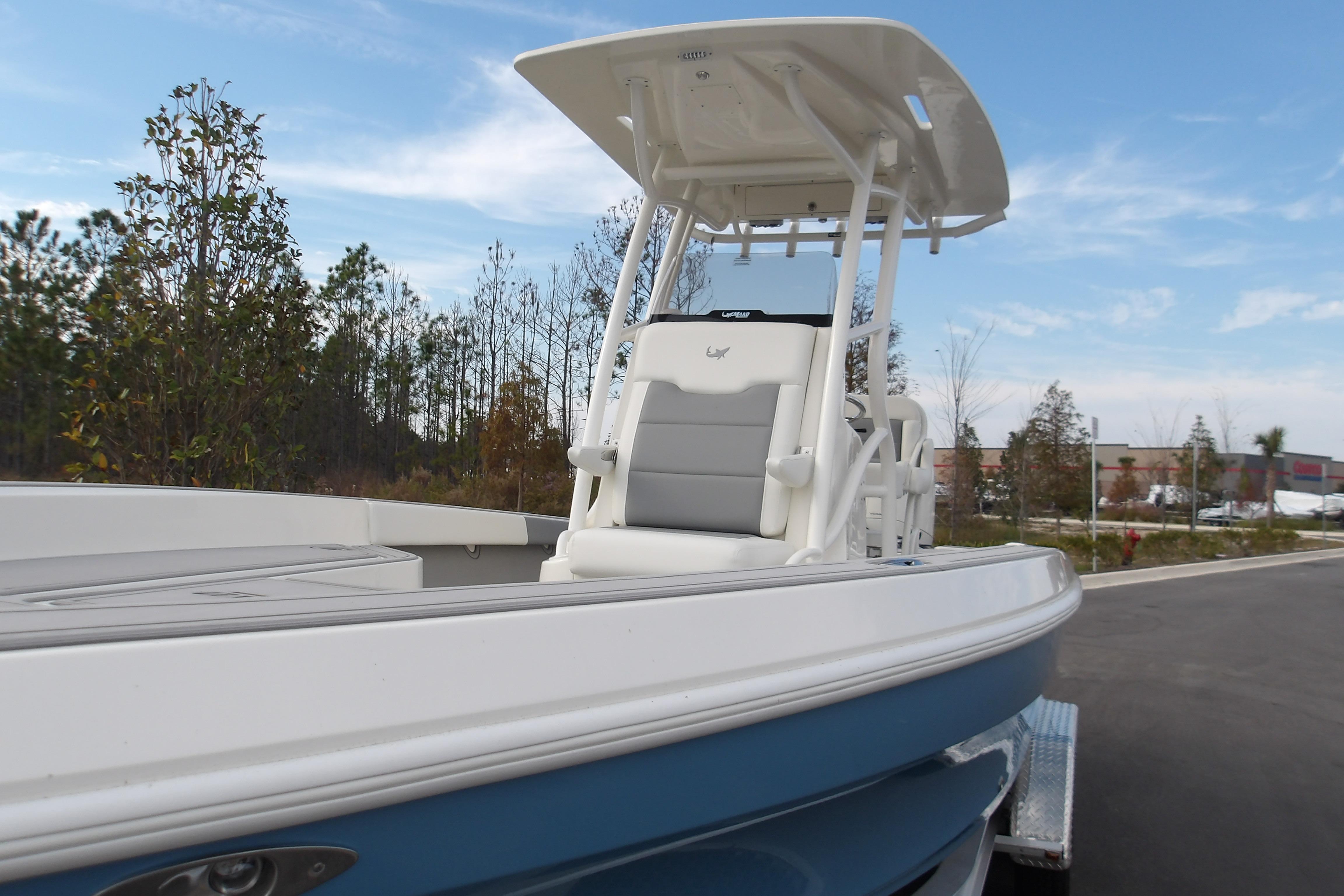 2026 Mako 24 APEX boat with T-top, parked outdoors on a trailer.