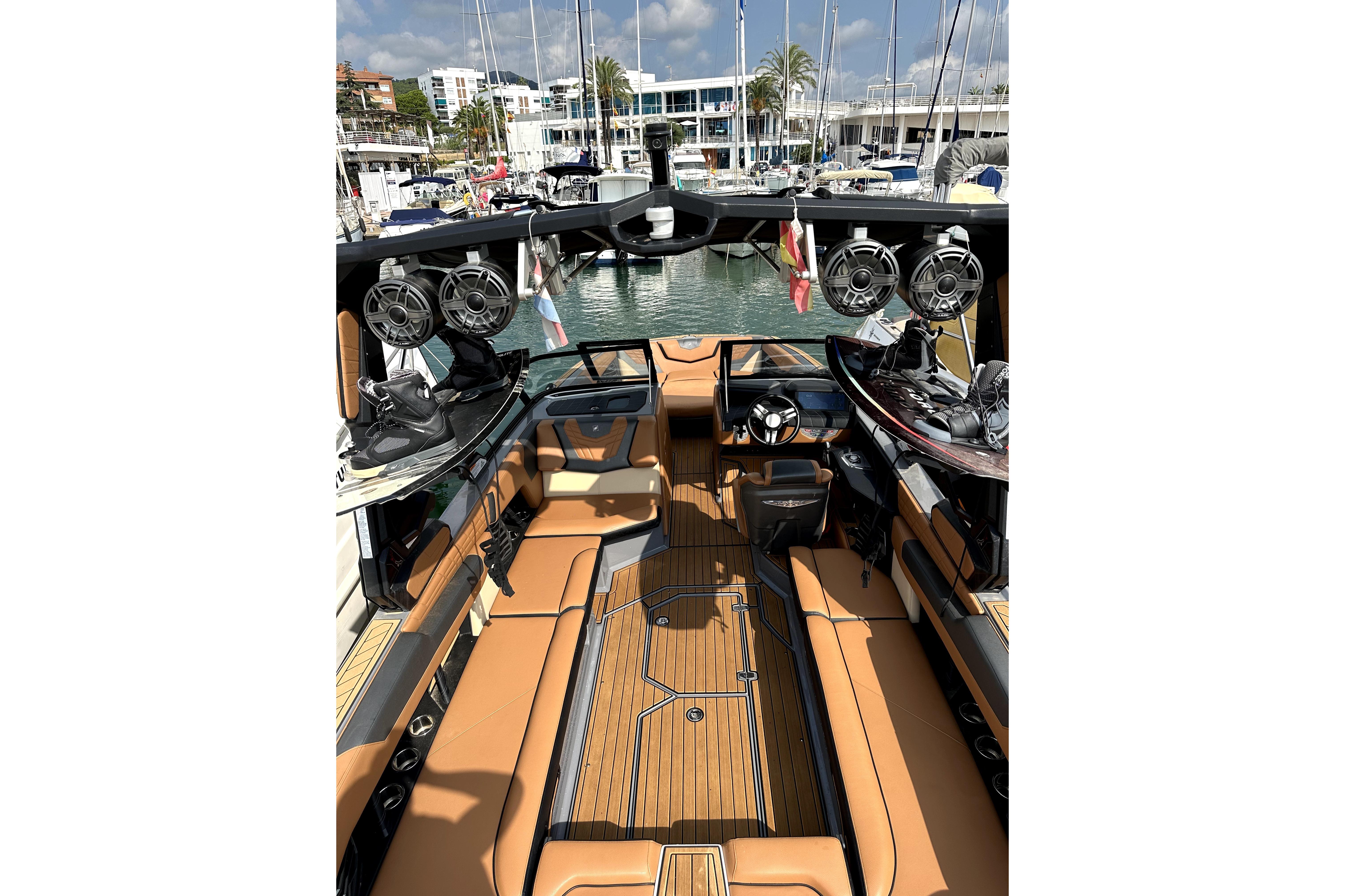 2022 Nautique Super Air Nautique G25 interior with luxury seating and wakeboard racks.