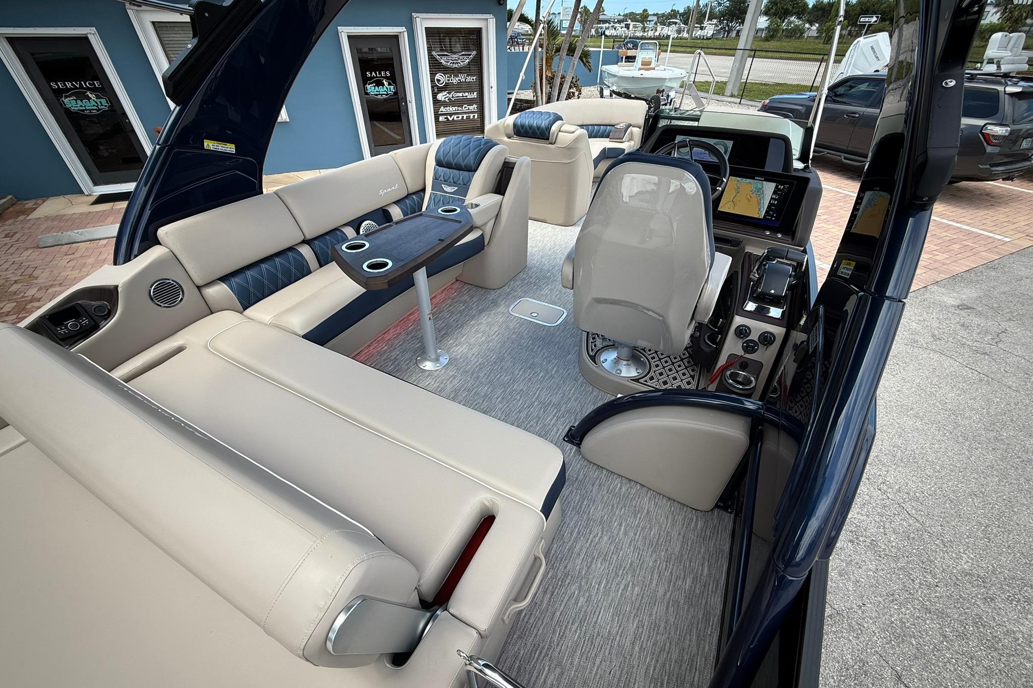 Luxurious interior of 2026 Bennington 27 QSBAT2 pontoon boat with plush seating and modern helm.
