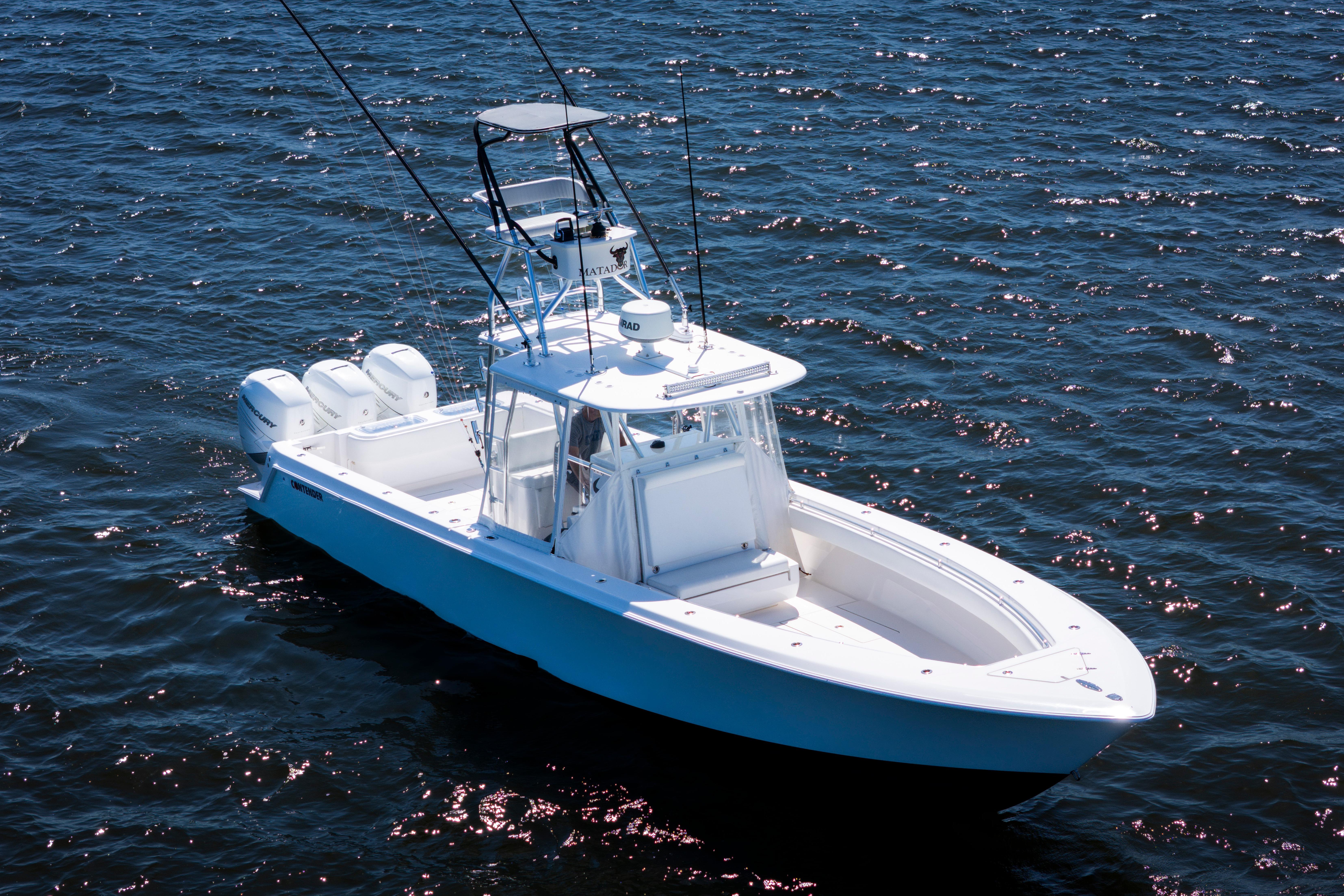 2015 Contender 39 ST boat on open water, featuring triple outboard engines.