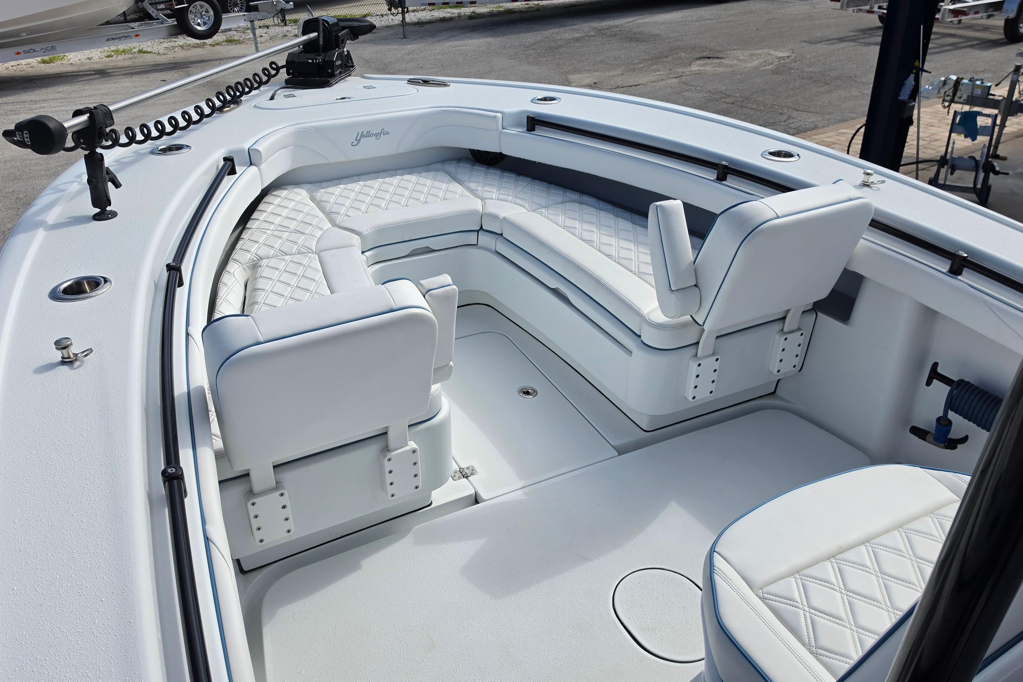 2025 Yellowfin 26 Hybrid boat interior with white cushioned seating and modern design.