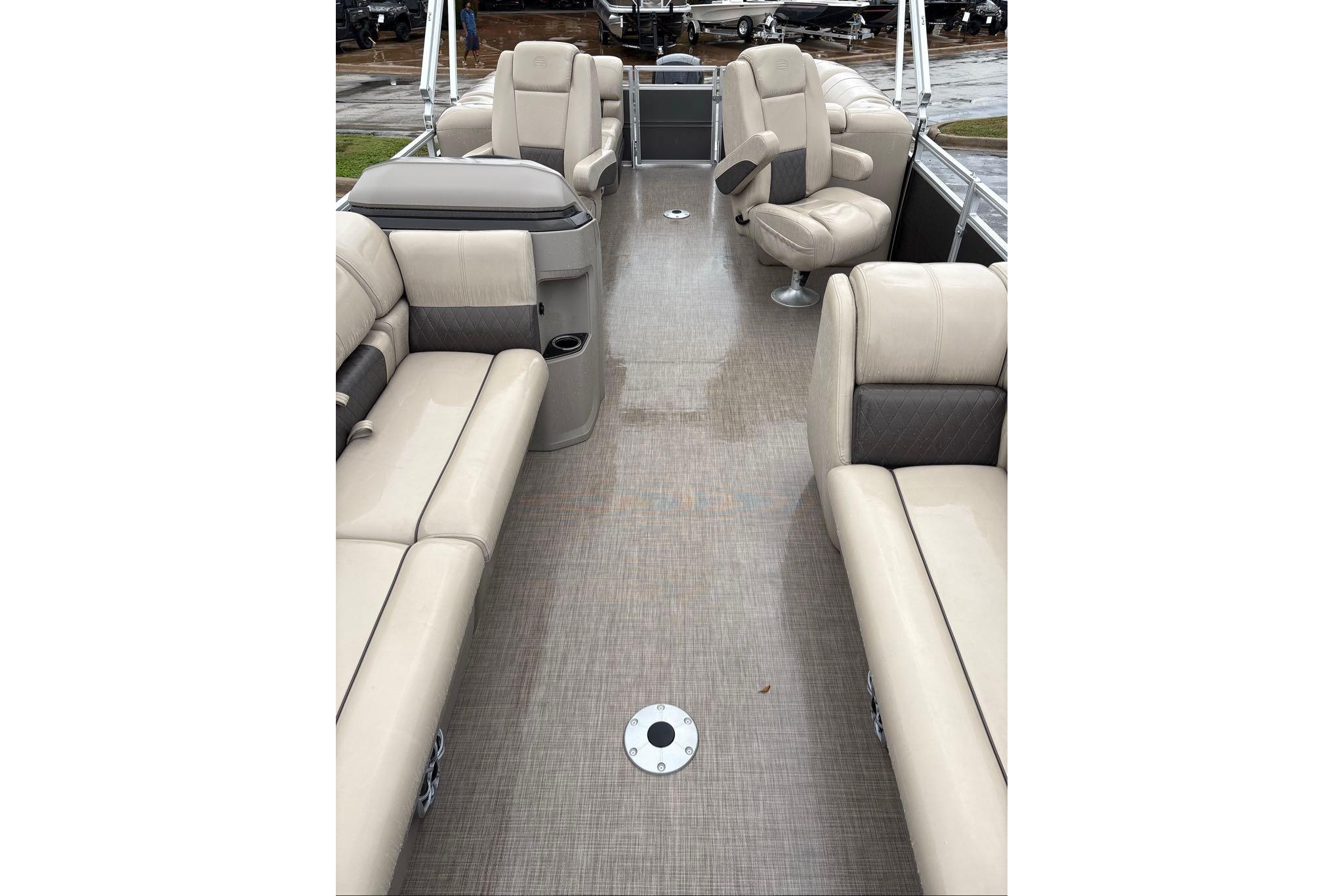 2024 Sun Tracker Party Barge 24 DLX interior with beige seating and spacious layout.