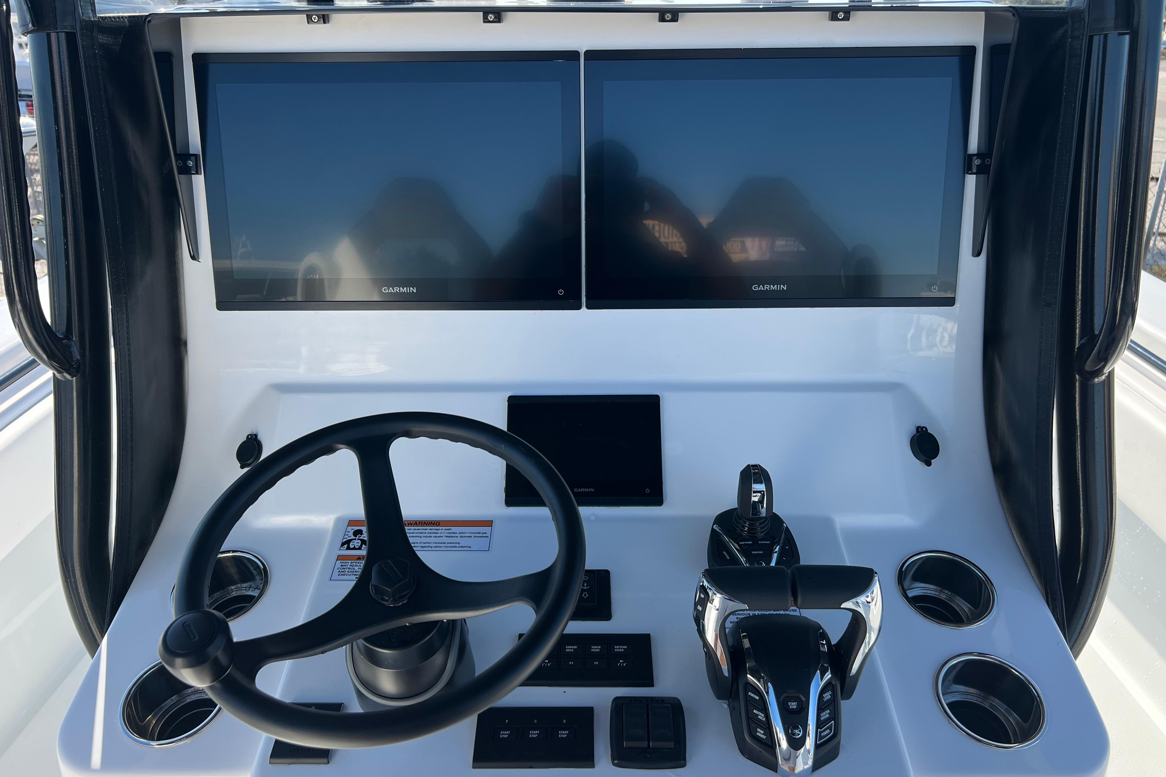 Helm of 2026 Contender 35 ST with dual Garmin displays and modern controls.