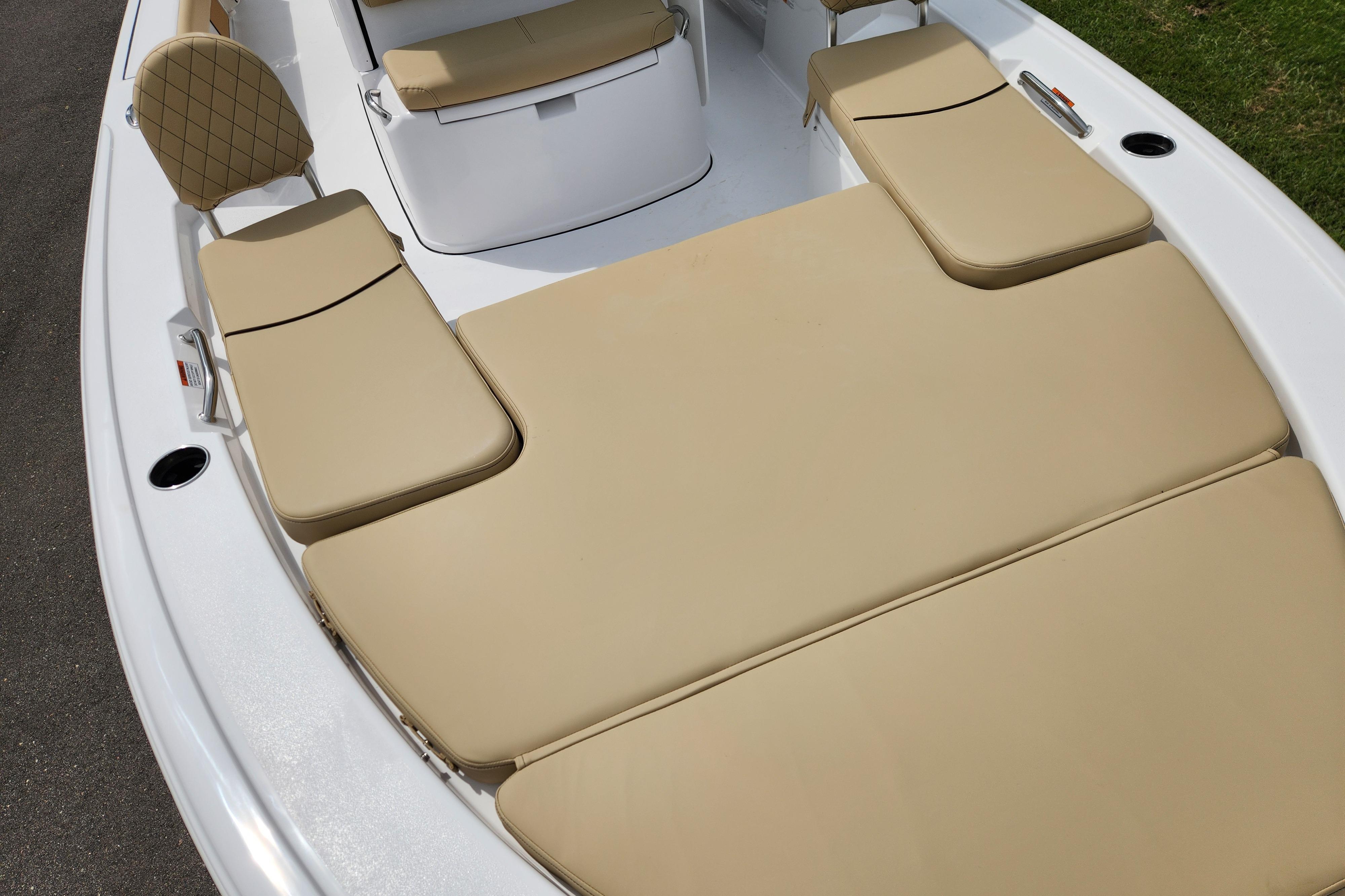 2026 Sportsman Masters 247 Bay Boat with beige cushioned seating and sleek white deck.