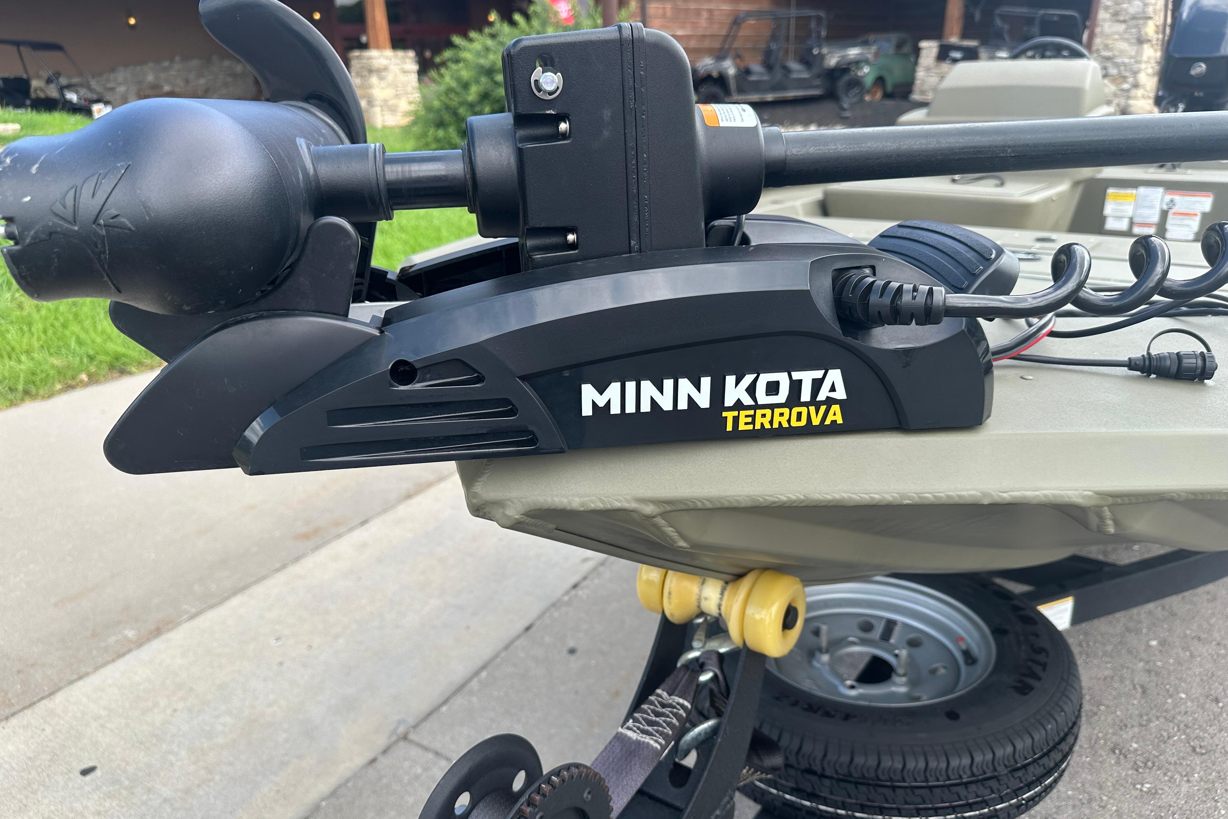 Minn Kota Terrova motor on 2024 Tracker Grizzly 1648 SC boat, parked outdoors.