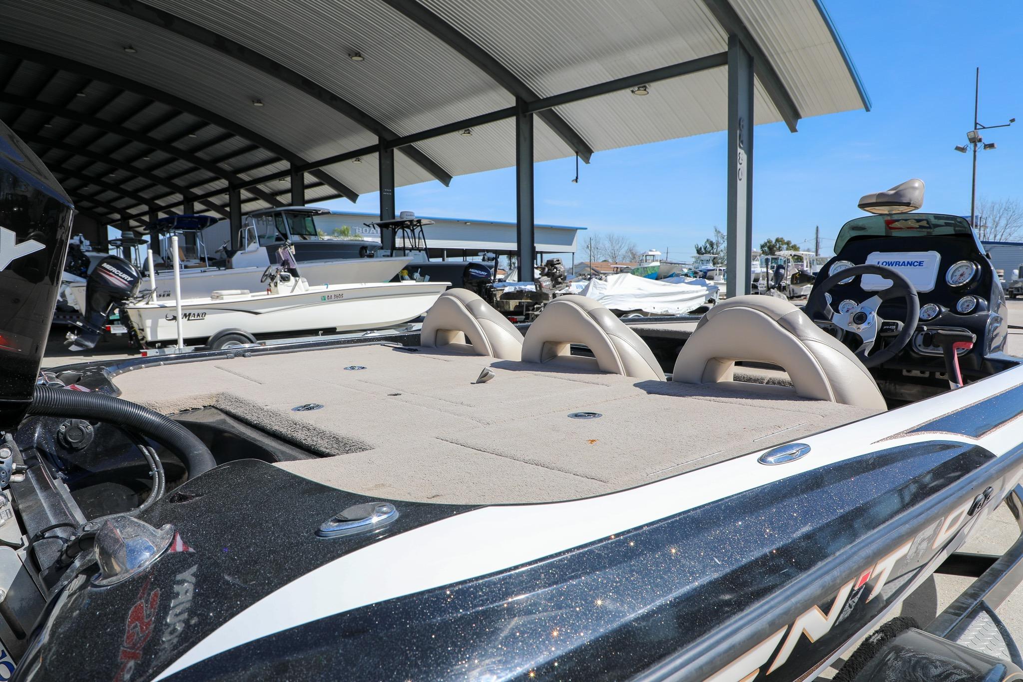 2013 Nitro Z-7 boat in marina, featuring spacious deck and modern steering console.