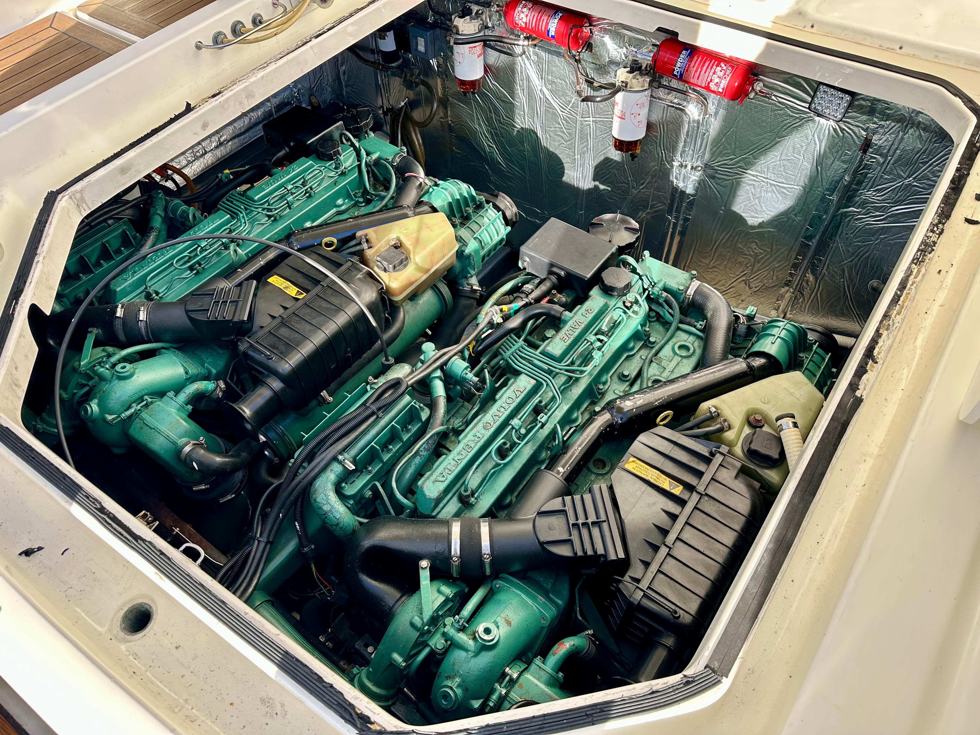 Engine compartment of a 1999 Cranchi Endurance 39 with dual green engines.