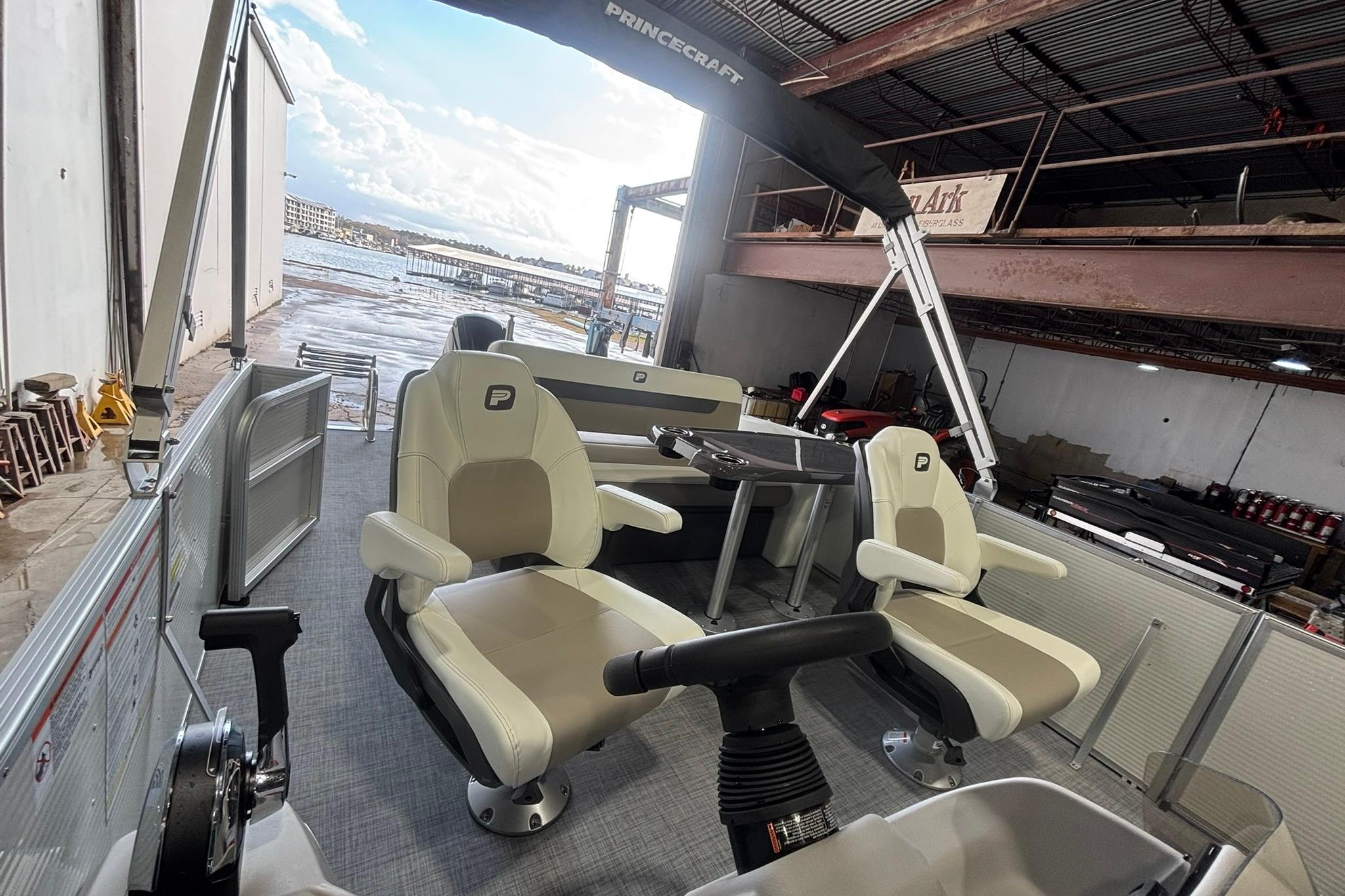 2025 Princecraft Vectra 21 RL pontoon boat interior with beige seating and steering console.