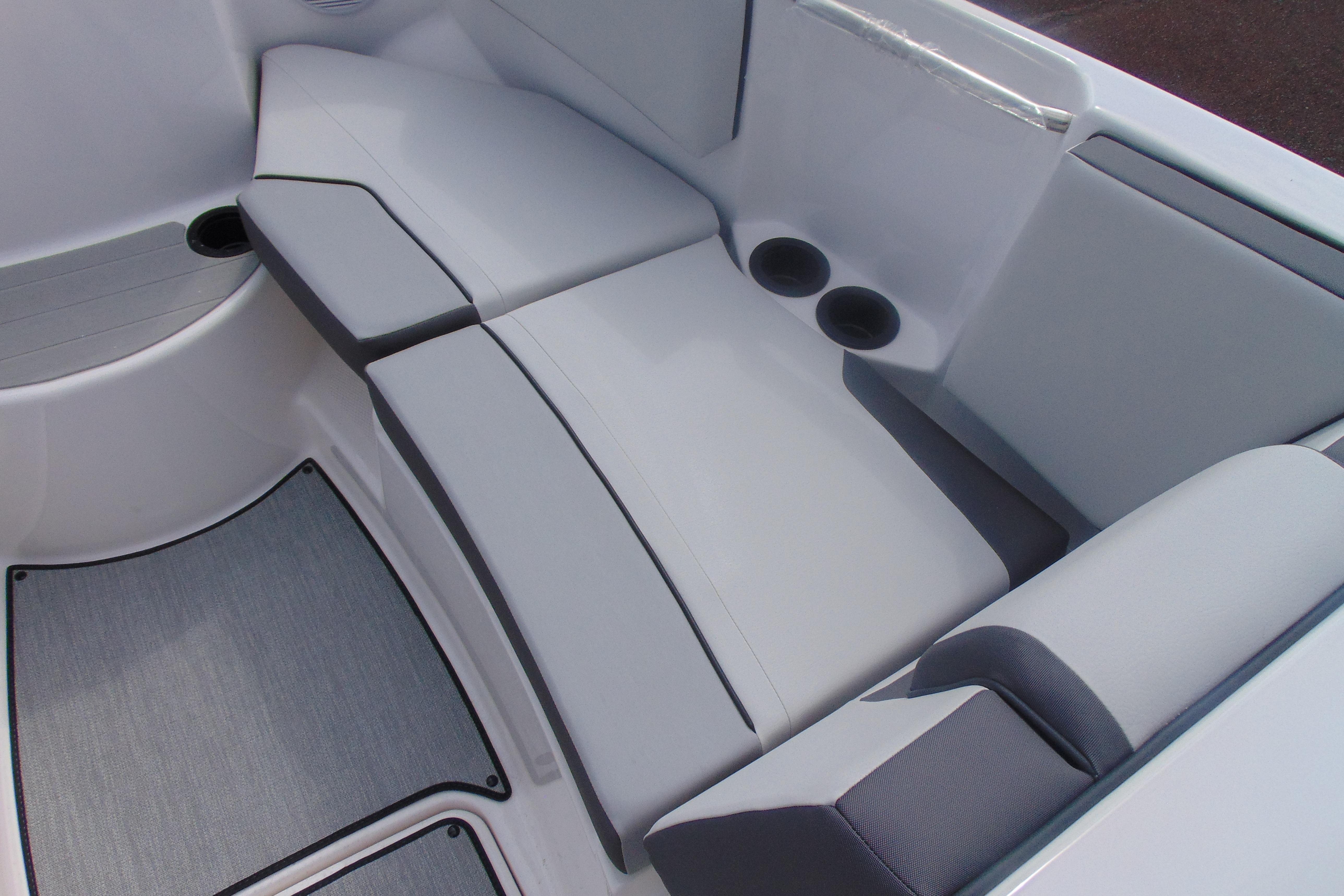 Interior seating of 2026 Yamaha Boats AR220 with cup holders and cushioned seats.
