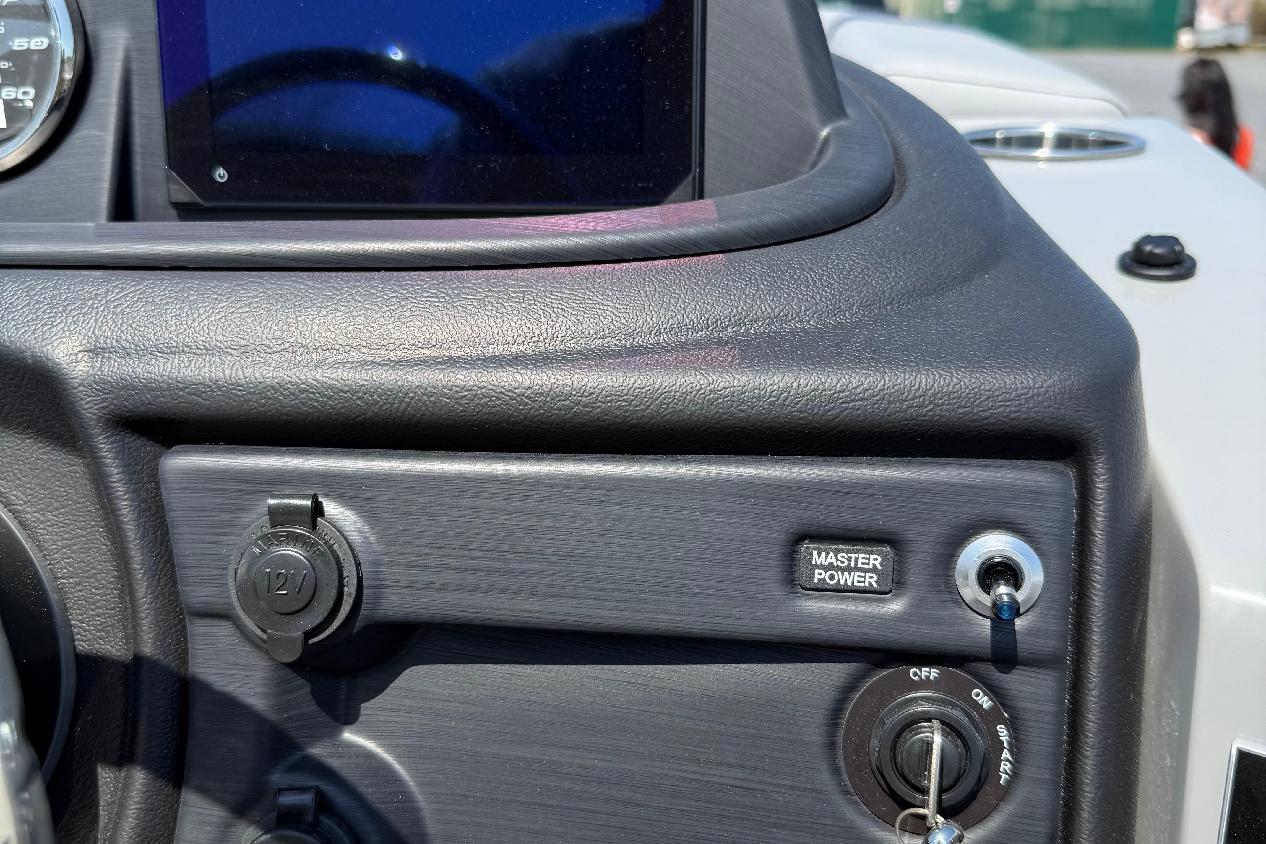 Dashboard of 2026 Berkshire 22CL2 CTS boat with master power switch and 12V outlet.