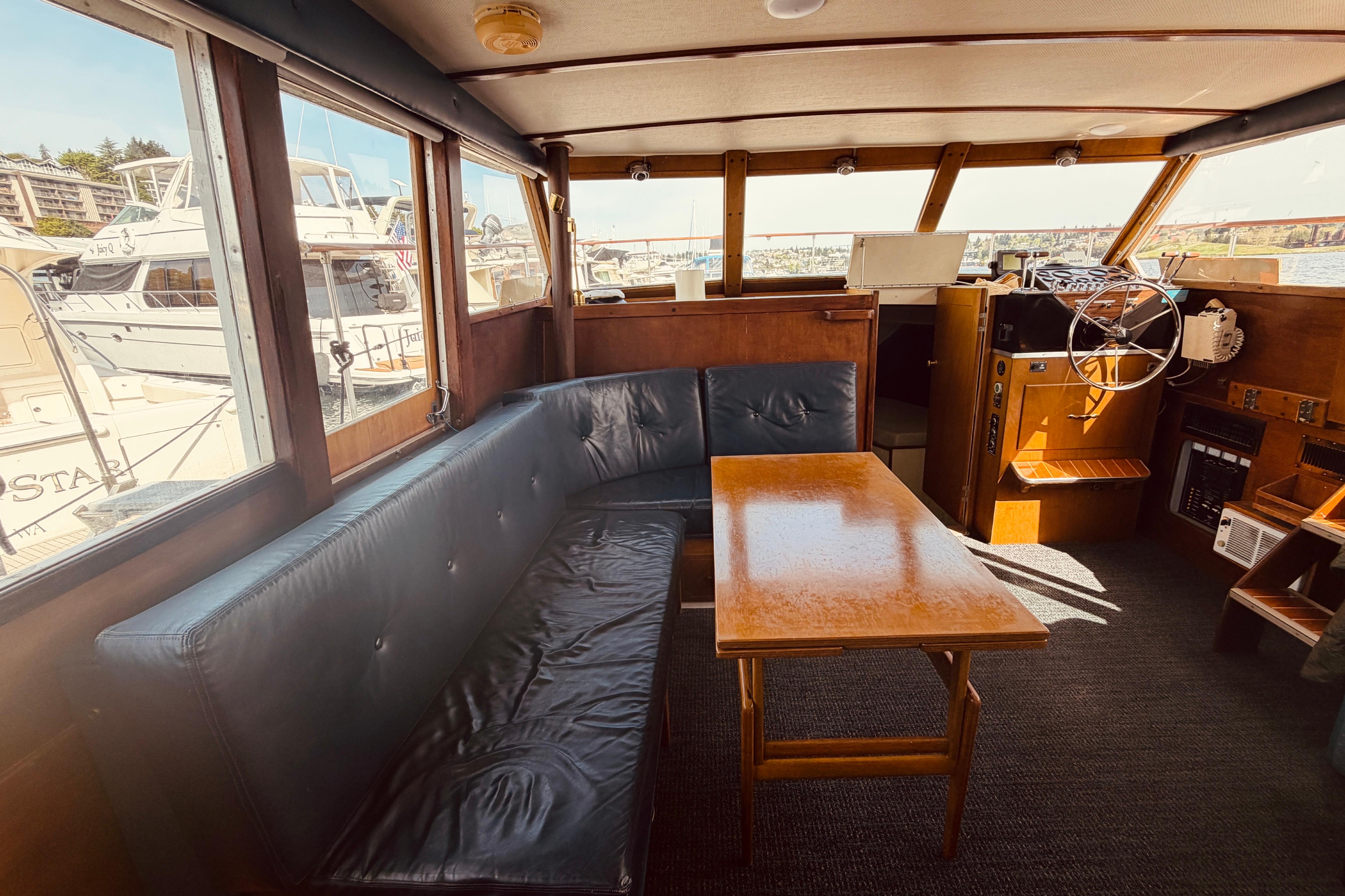 Interior of 1972 Tollycraft 40 Tri-Cabin Motor Yacht with seating and helm.