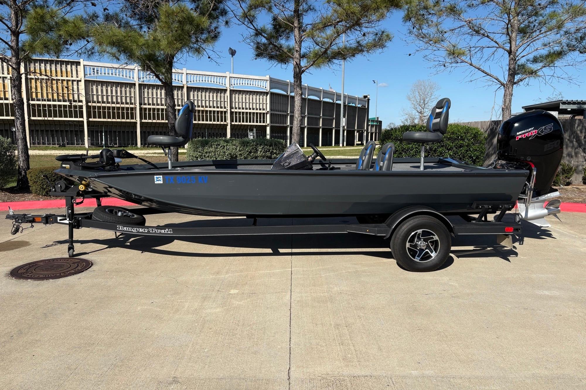 2024 Ranger RT198P fishing boat on trailer, parked outdoors.