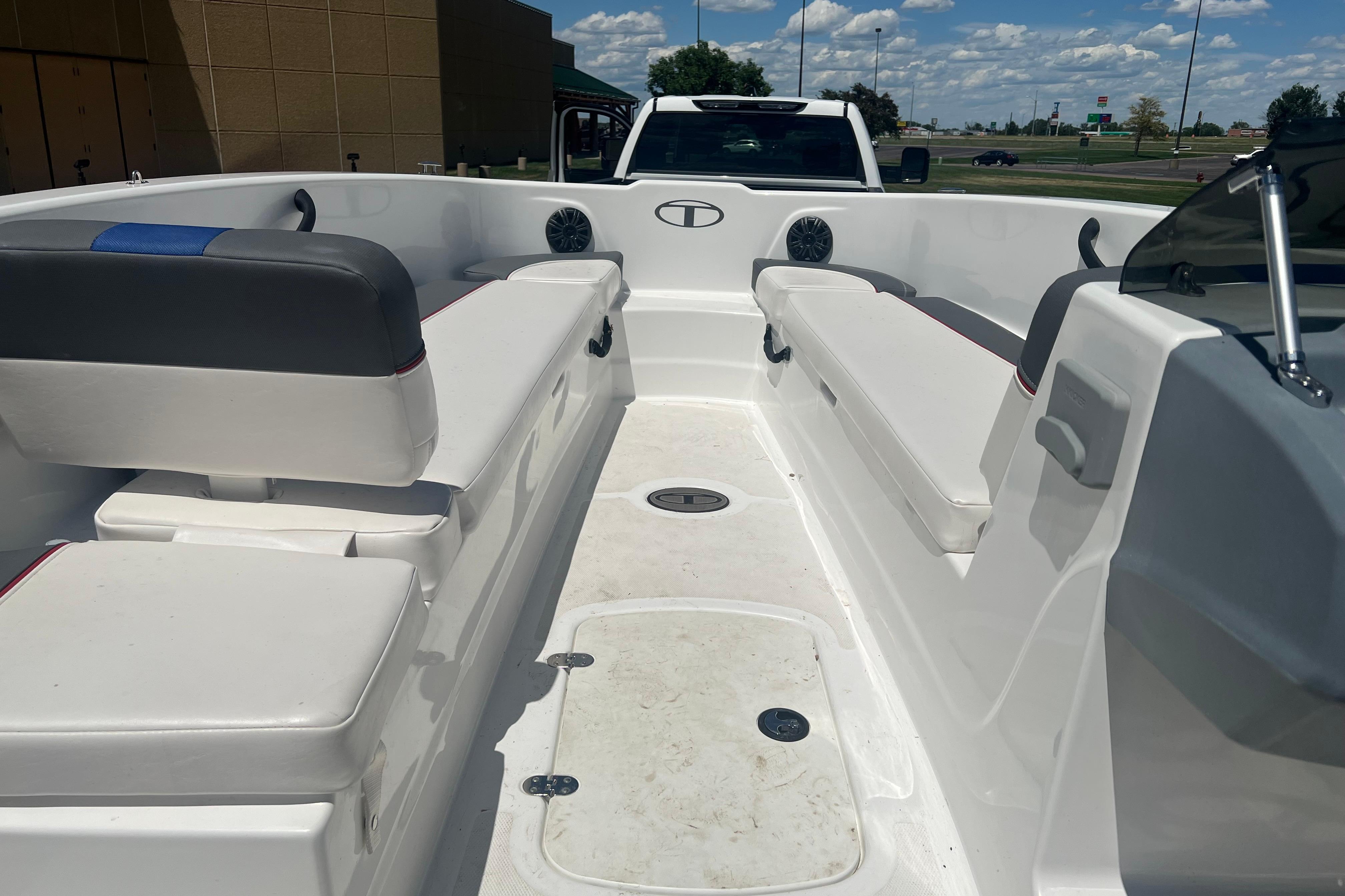 Interior view of a 2023 Tahoe T18 boat with seating and storage compartments.