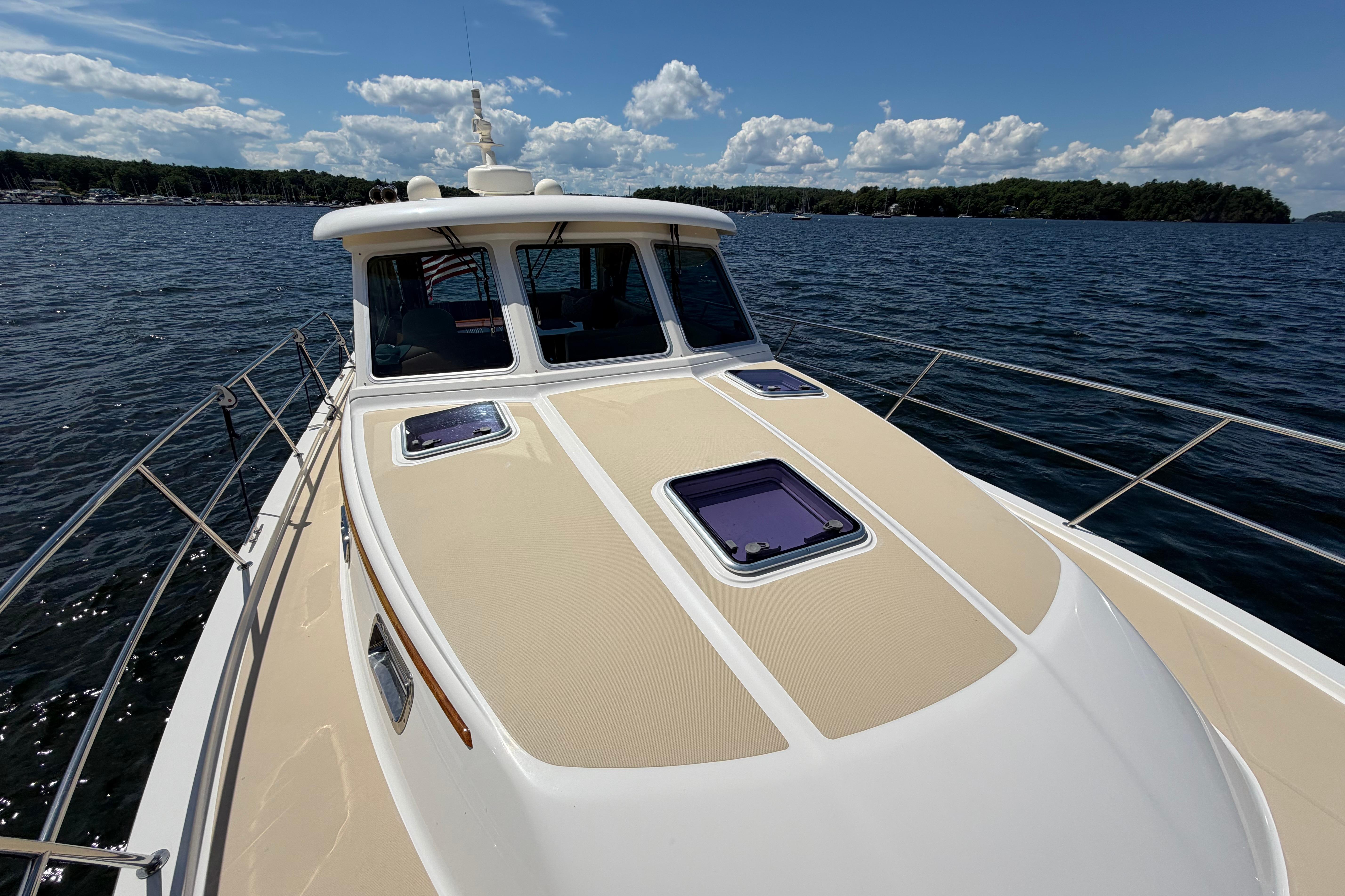 2015 Sabre 38 Salon Express yacht cruising on a sunny day with scenic water views.