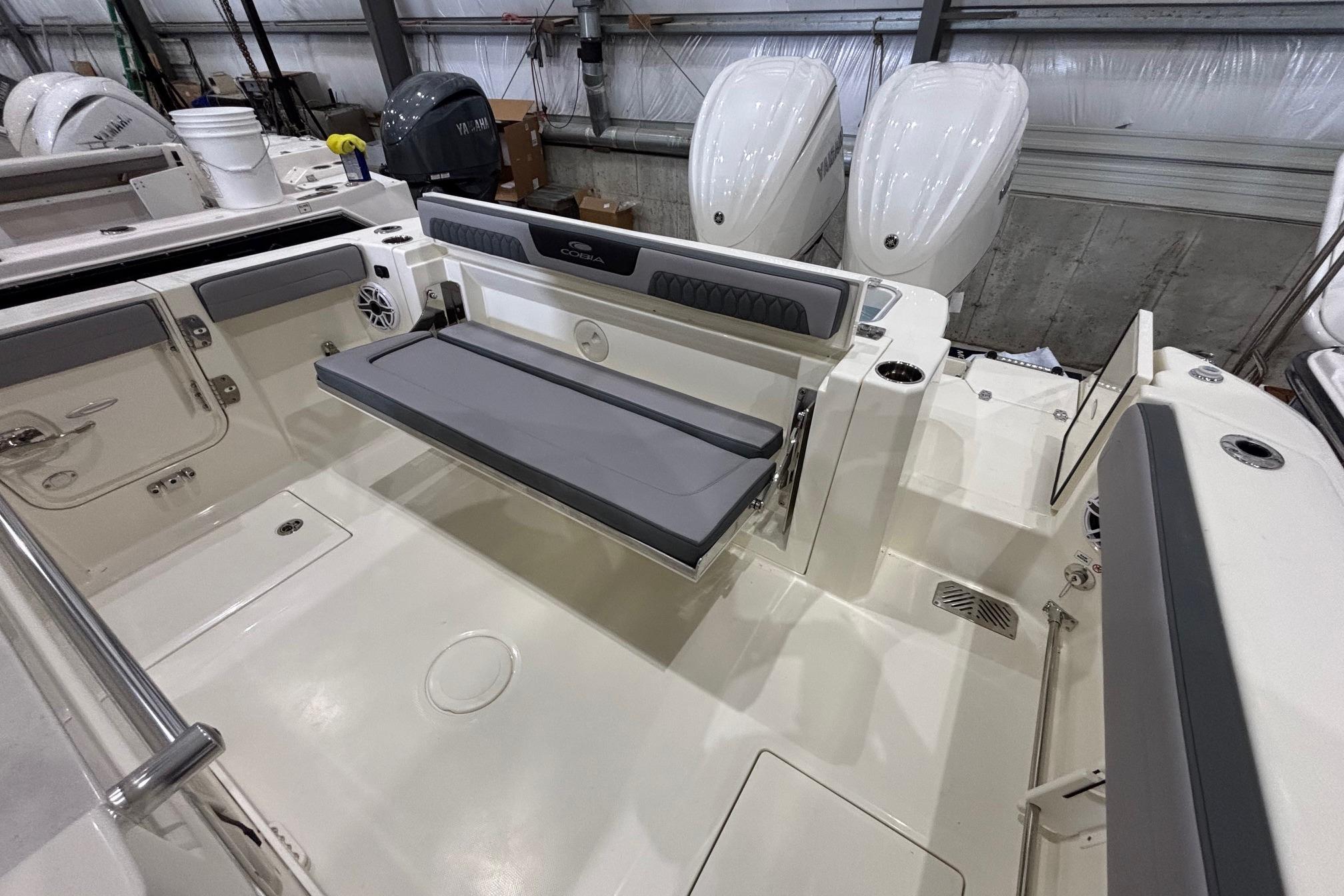 2026 Cobia 285 Open Center Console boat interior with seating and dual engines.
